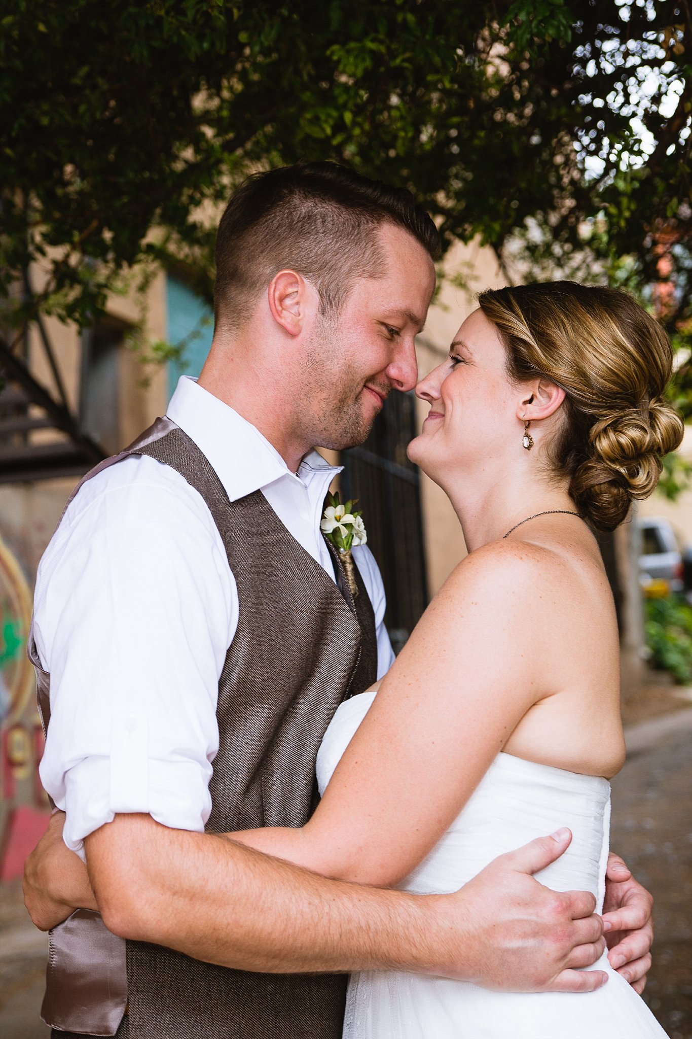 A sweet moment between the bride and groom by PMA Photography.