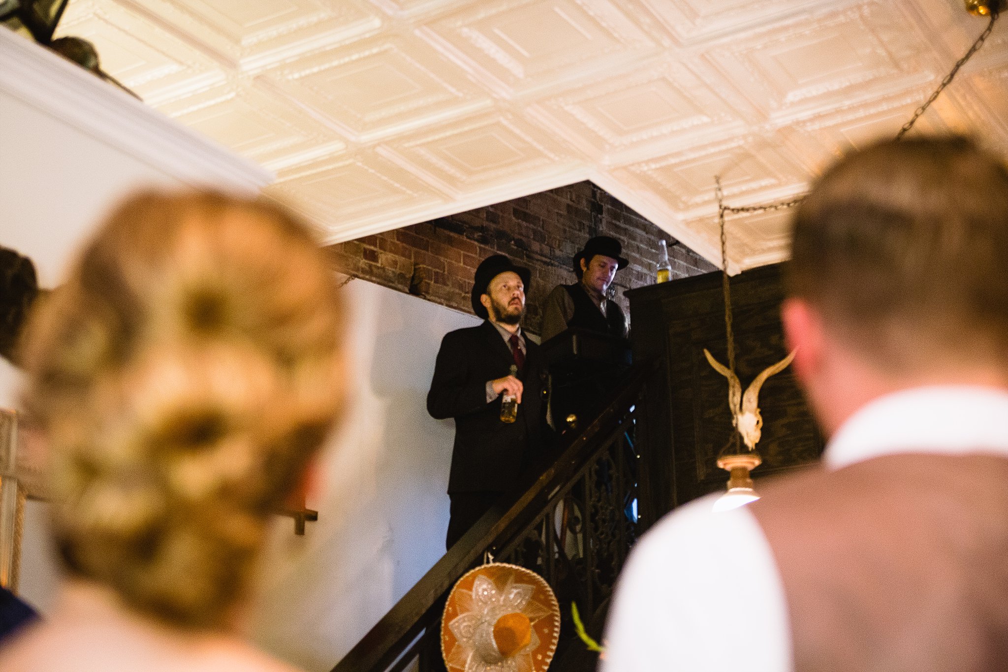 Band performing on stairwell at wedding reception in Bisbee Arizona by PMA Photography