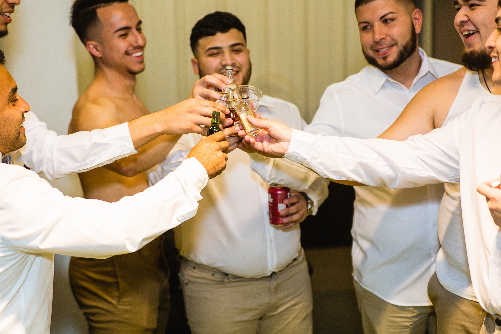 Groomsmen toasting while getting ready at Legacy Golf Resort in Phoenix, Arizona by PMA Photography