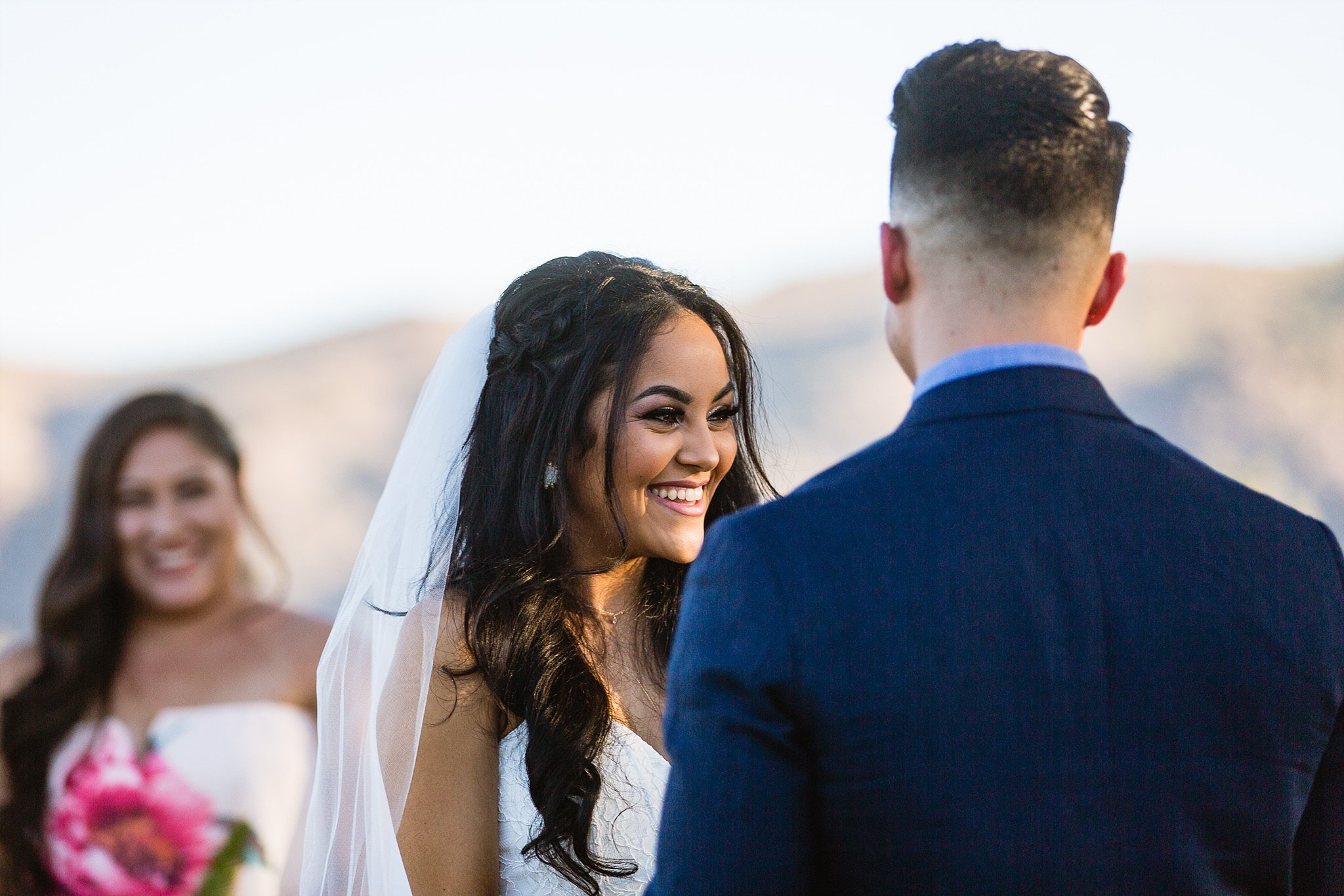 Bride smiling during ceremony at Legacy Golf Resort in Phoenix, Arizona by PMA Photography