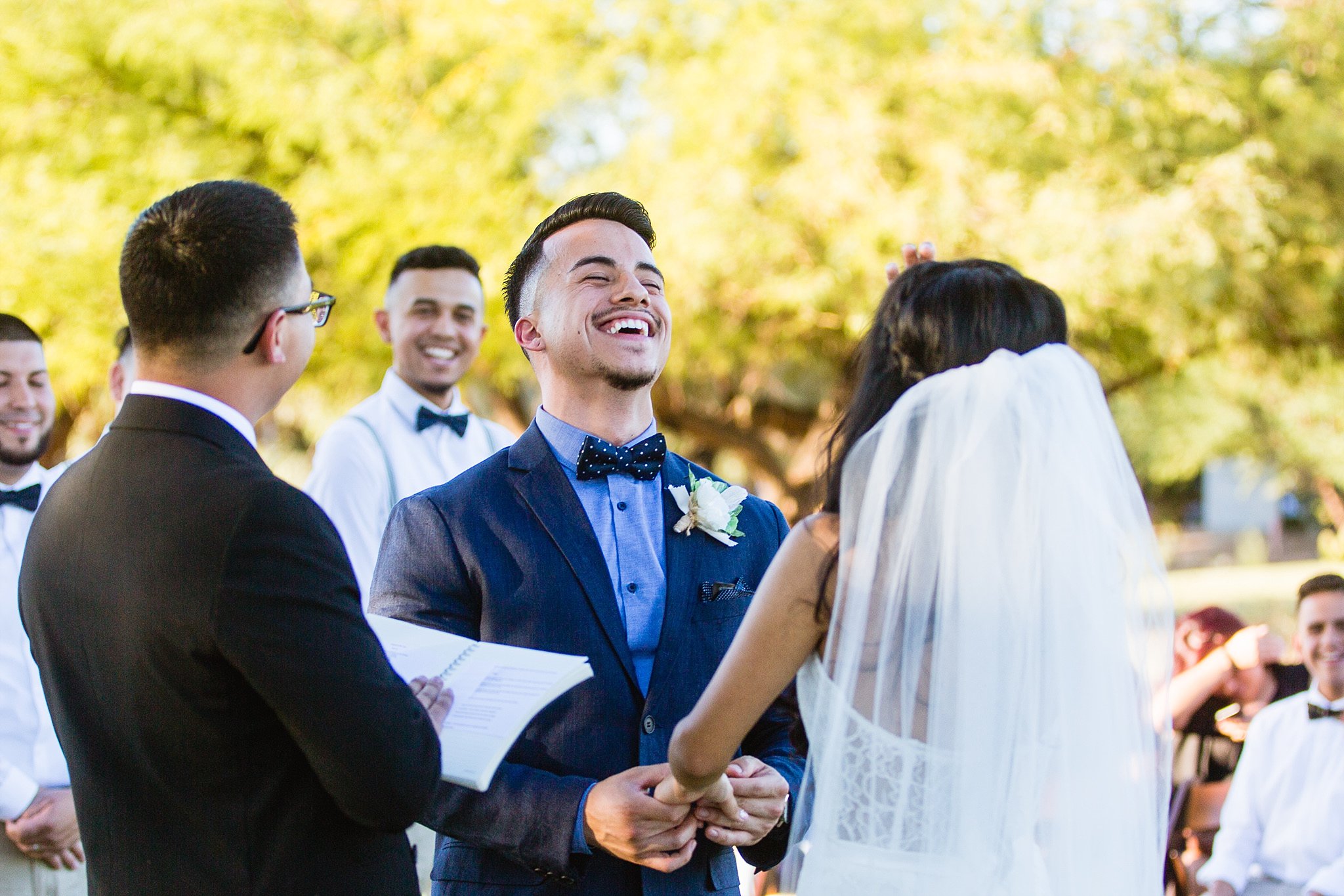 Groom and bride laughing during wedding ceremony at Legacy Golf Resort in Phoenix, Arizona by PMA Photography