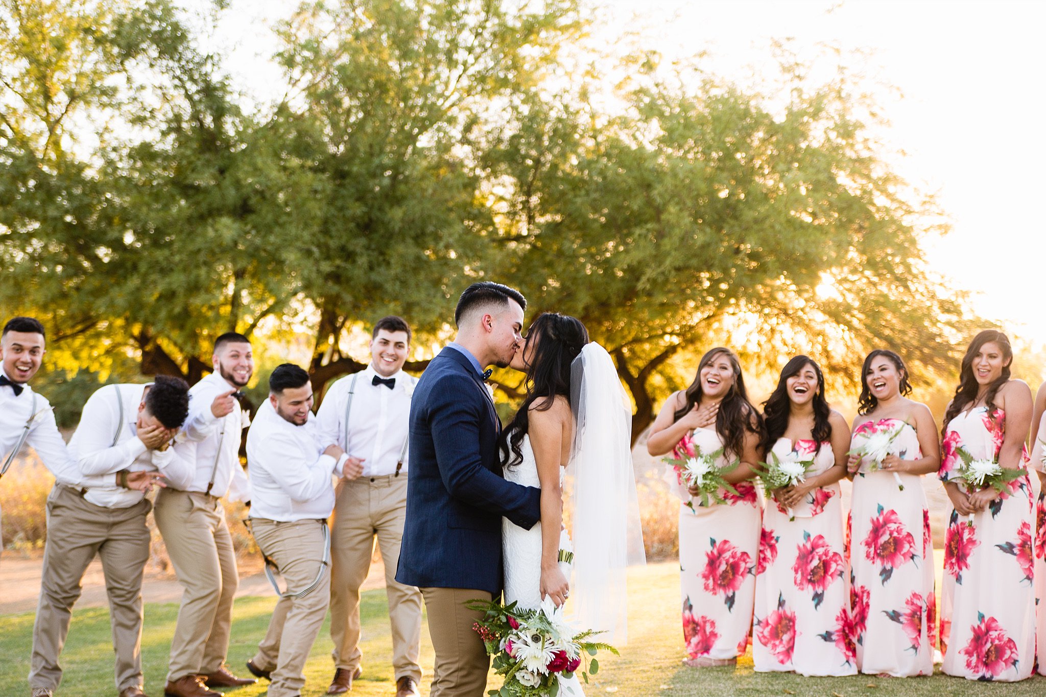 Bride and Groom kissing with Bridal Party at Legacy Golf Resort in Phoenix, Arizona by PMA Photography