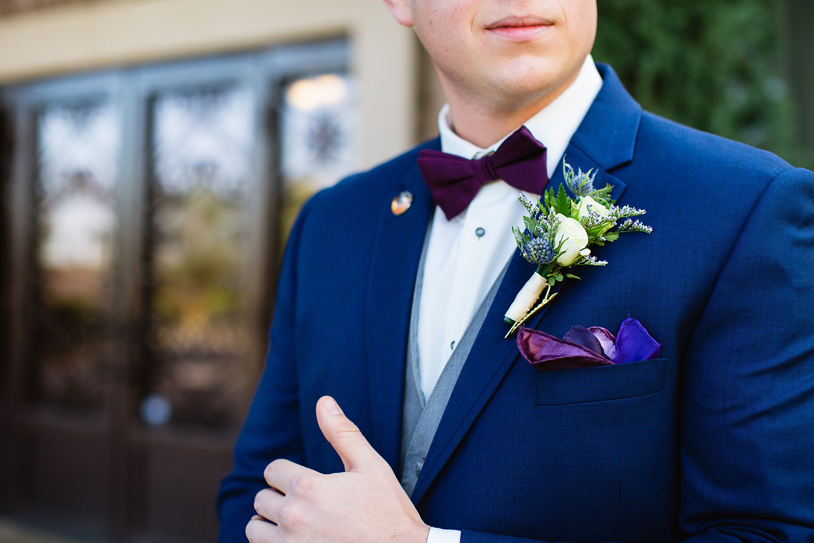 Detail image of groom's boutonniere while he is getting ready for his wedding day by Phoenix wedding photographers PMA Photography.