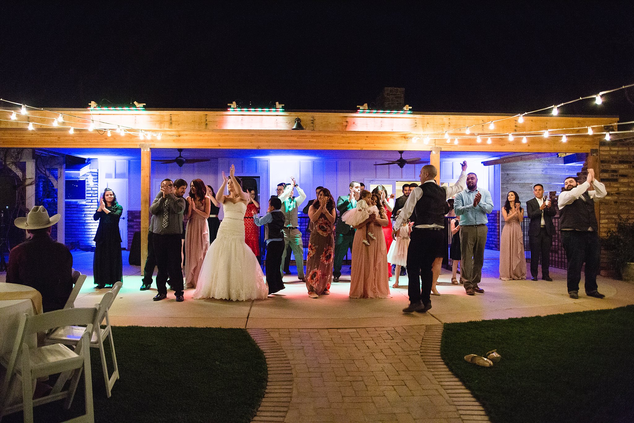 Bride and groom dancing with guests at their Schnepf Farms wedding reception by Arizona wedding photographer PMA Photography