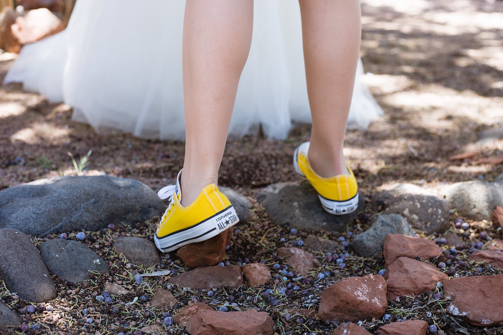 Bridesmaid's yellow converse while she helps the bride get ready for her wedding day by PMA Photography.