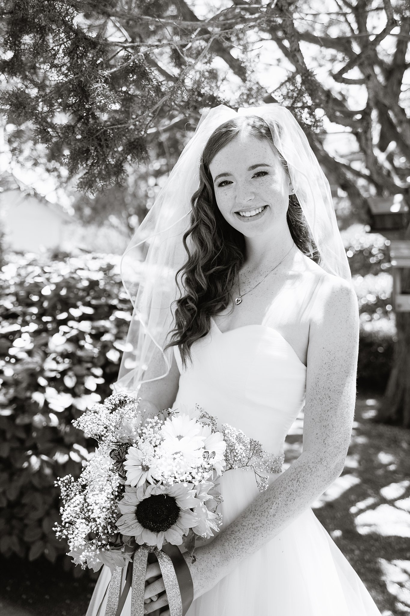 Black and white image of a casual bride on her wedding day by PMA Photography.