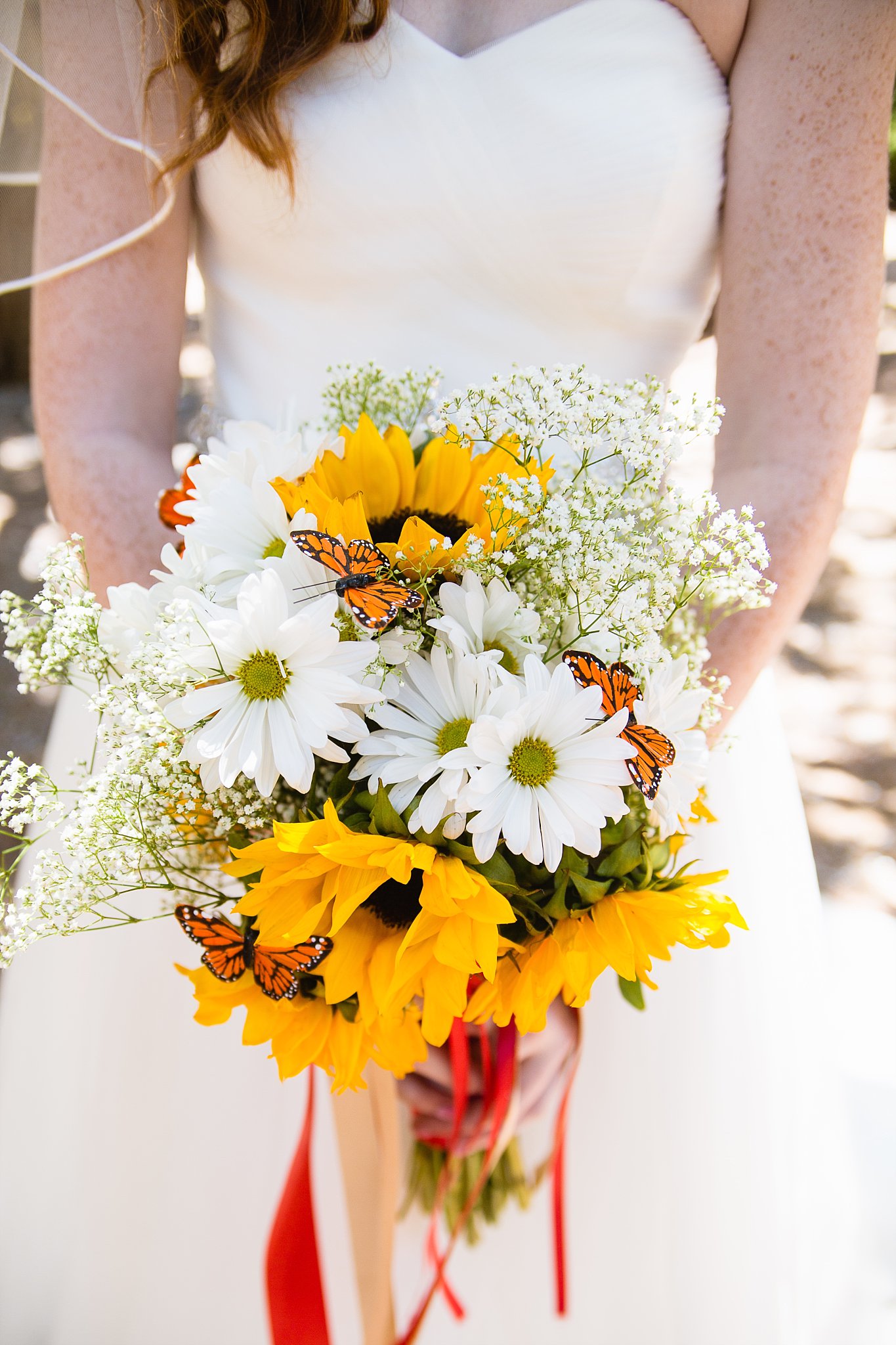 Bride's sunflower and butterfly bouquet by PMA Photography.