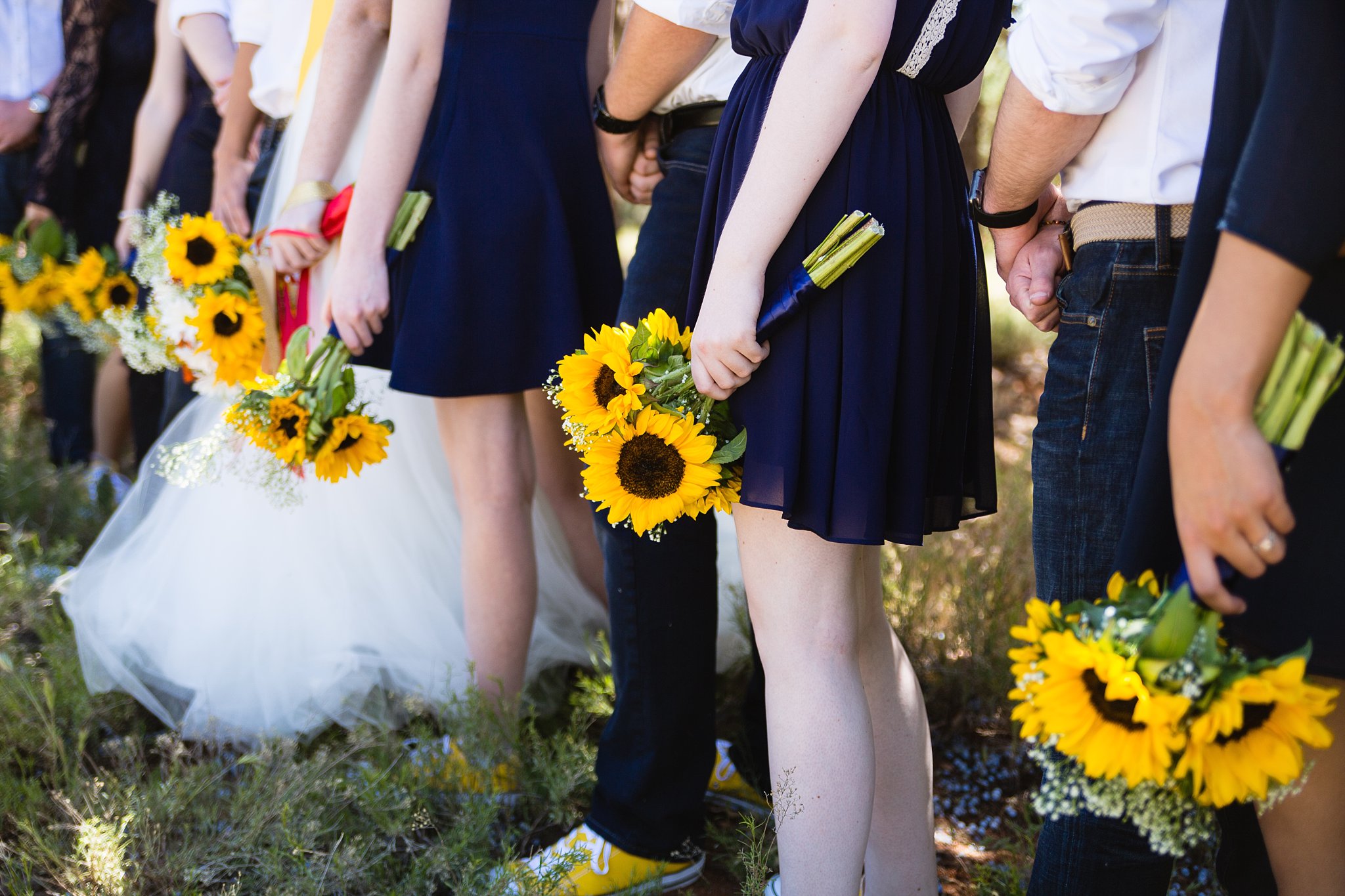 Close up image of bridesmaids' sunflower bouquets by PMA Photography.