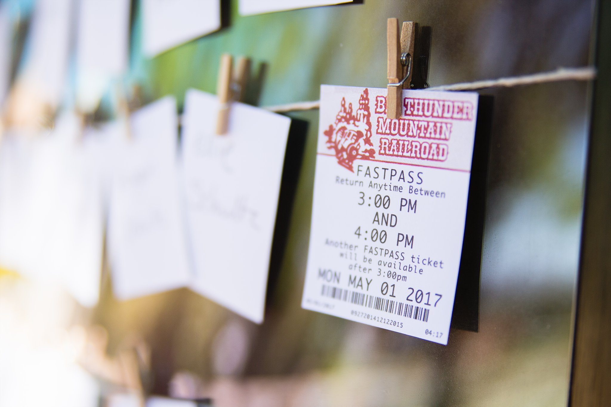Disneyland inspired fastpass escort cards for wedding reception by PMA Photography.