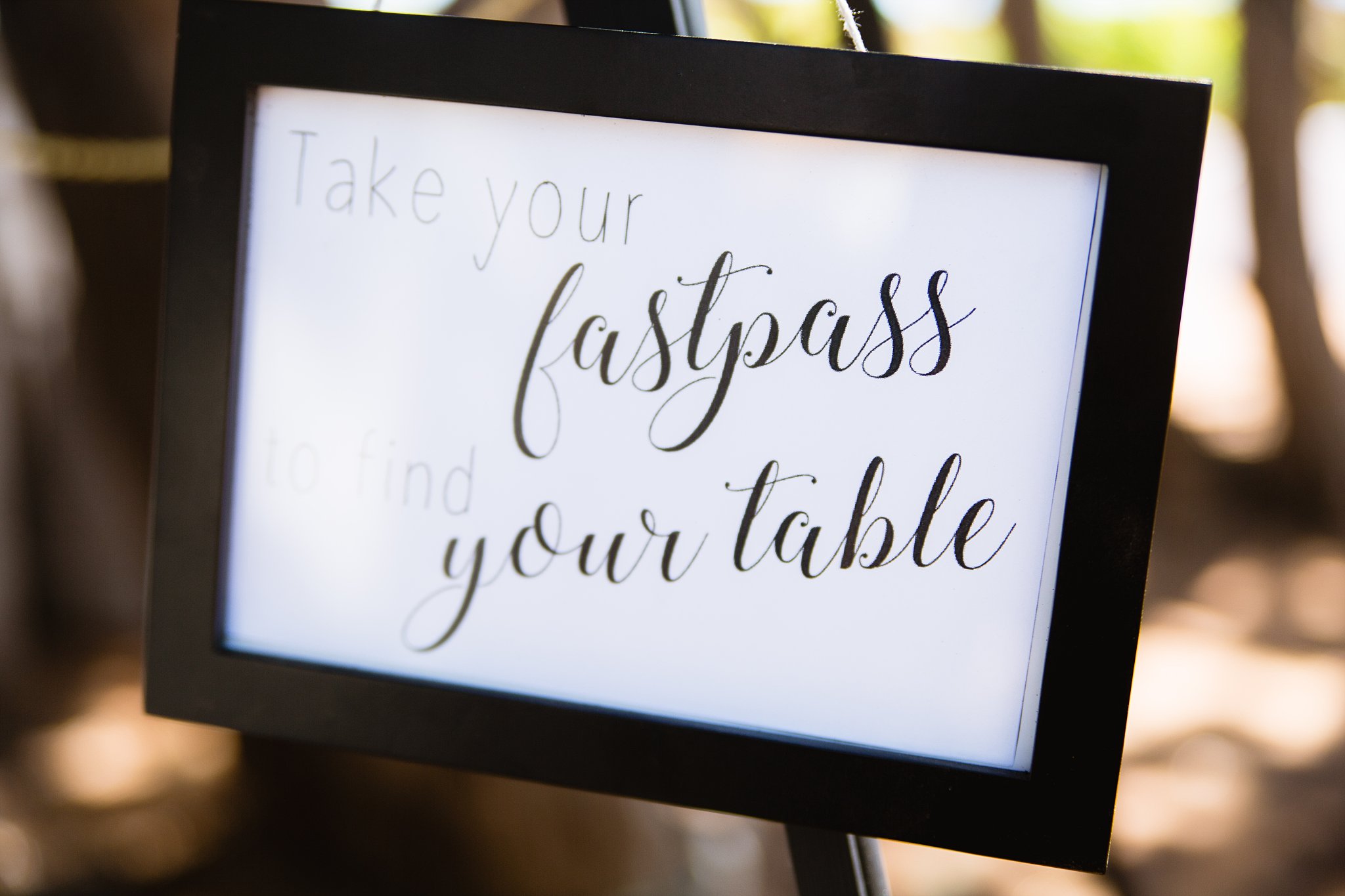Disneyland inspired fastpass escort cards for wedding reception by PMA Photography.