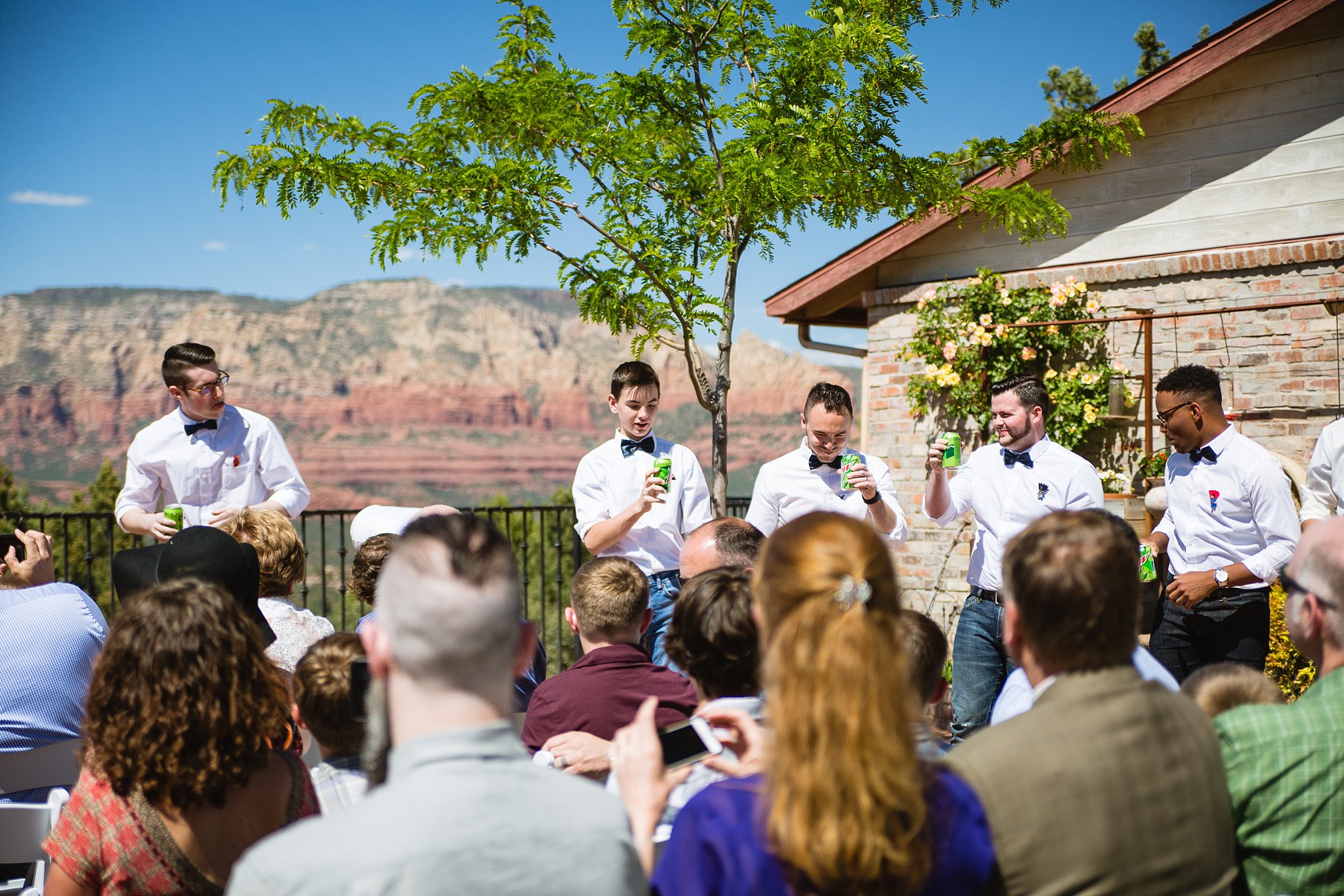 Groomsmen toast with Mountain Dew when the groom says "I Do" by PMA Photography.