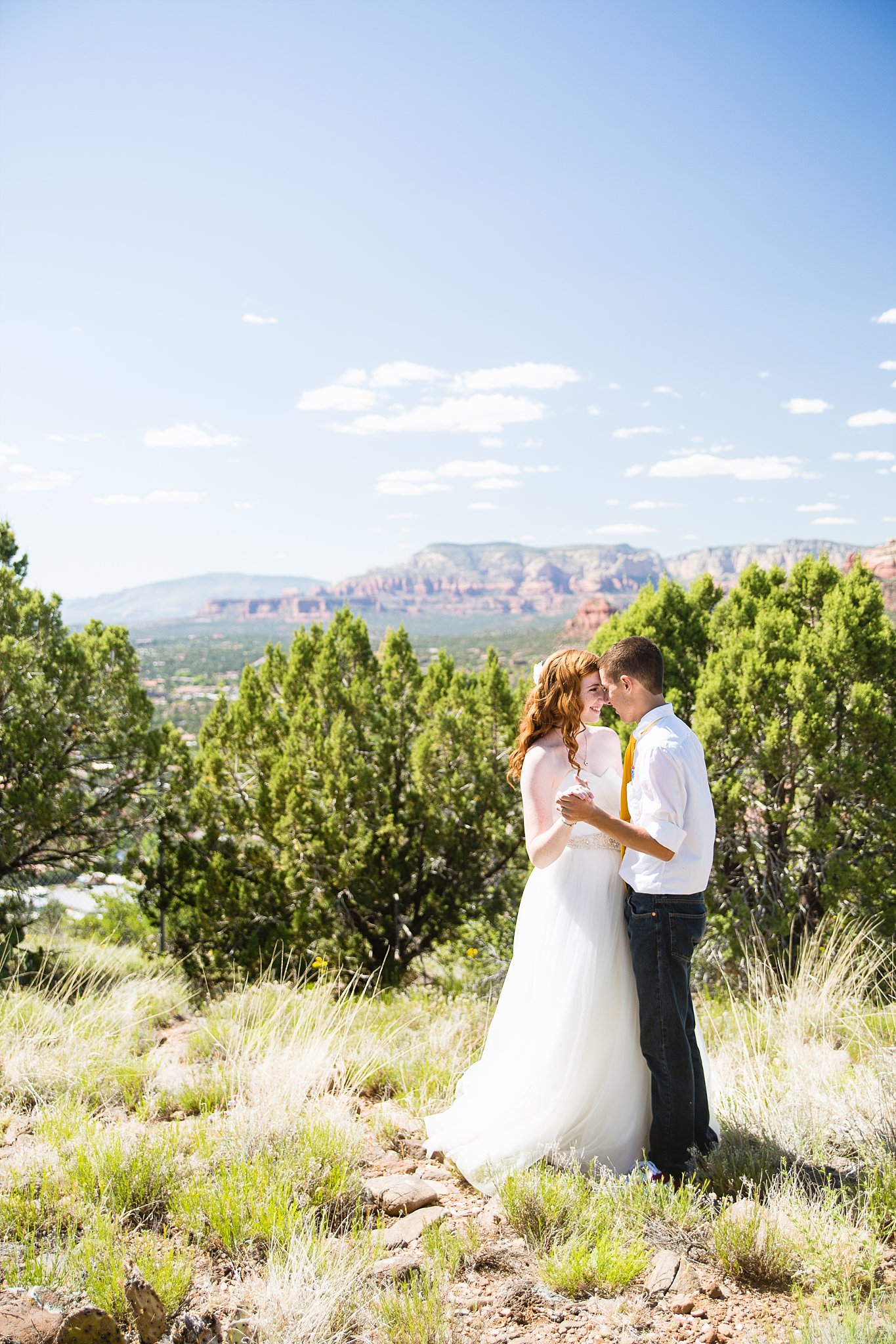 Bride and groom share an intimate moment during their Sky Ranch Lodge wedding by Sedona engagement photographer PMA Photography.