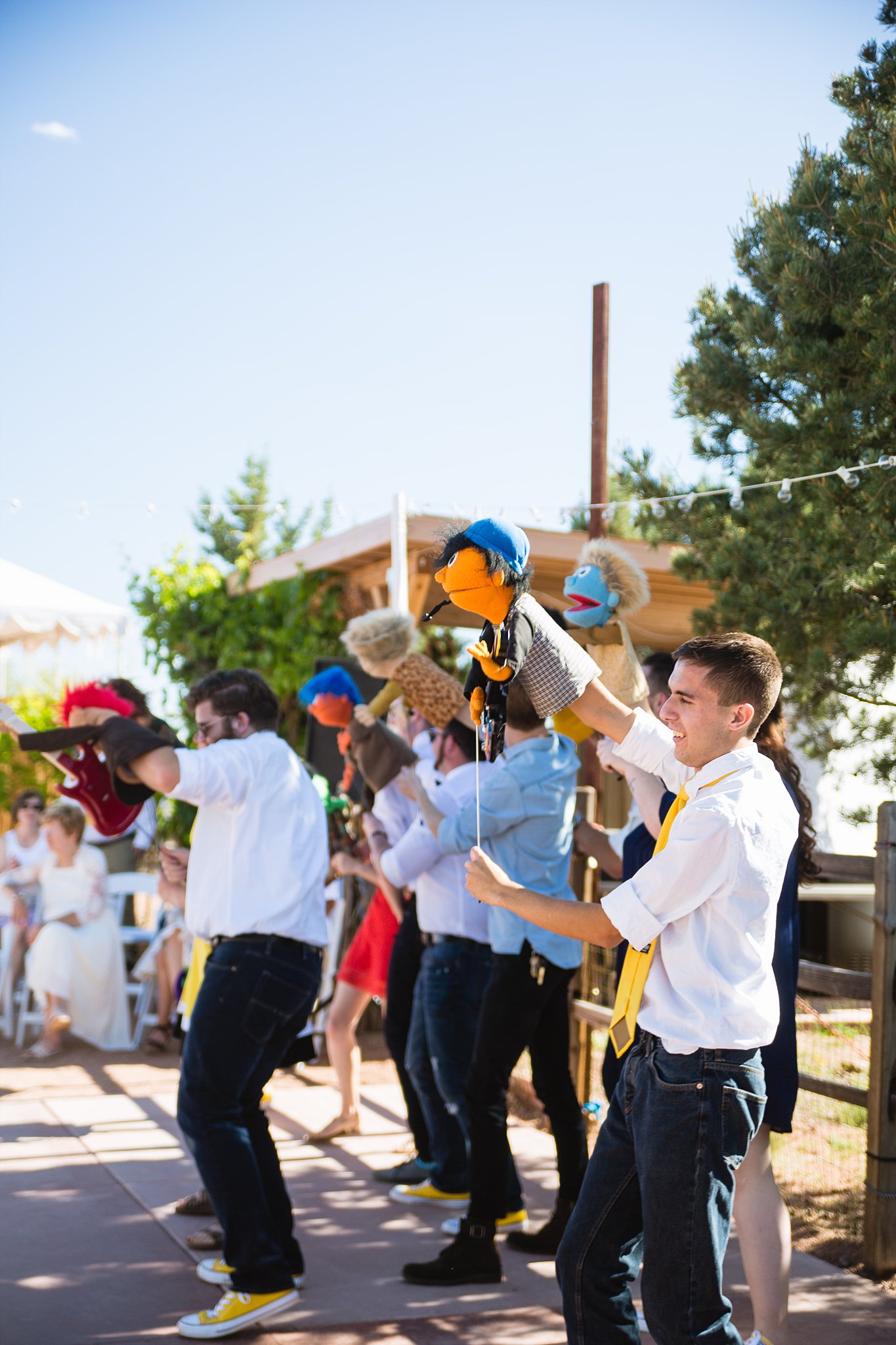 Groom and guests perform a Muppet show for guests at a Sky Ranch Lodge wedding by Sedona wedding photographer PMA Photography.