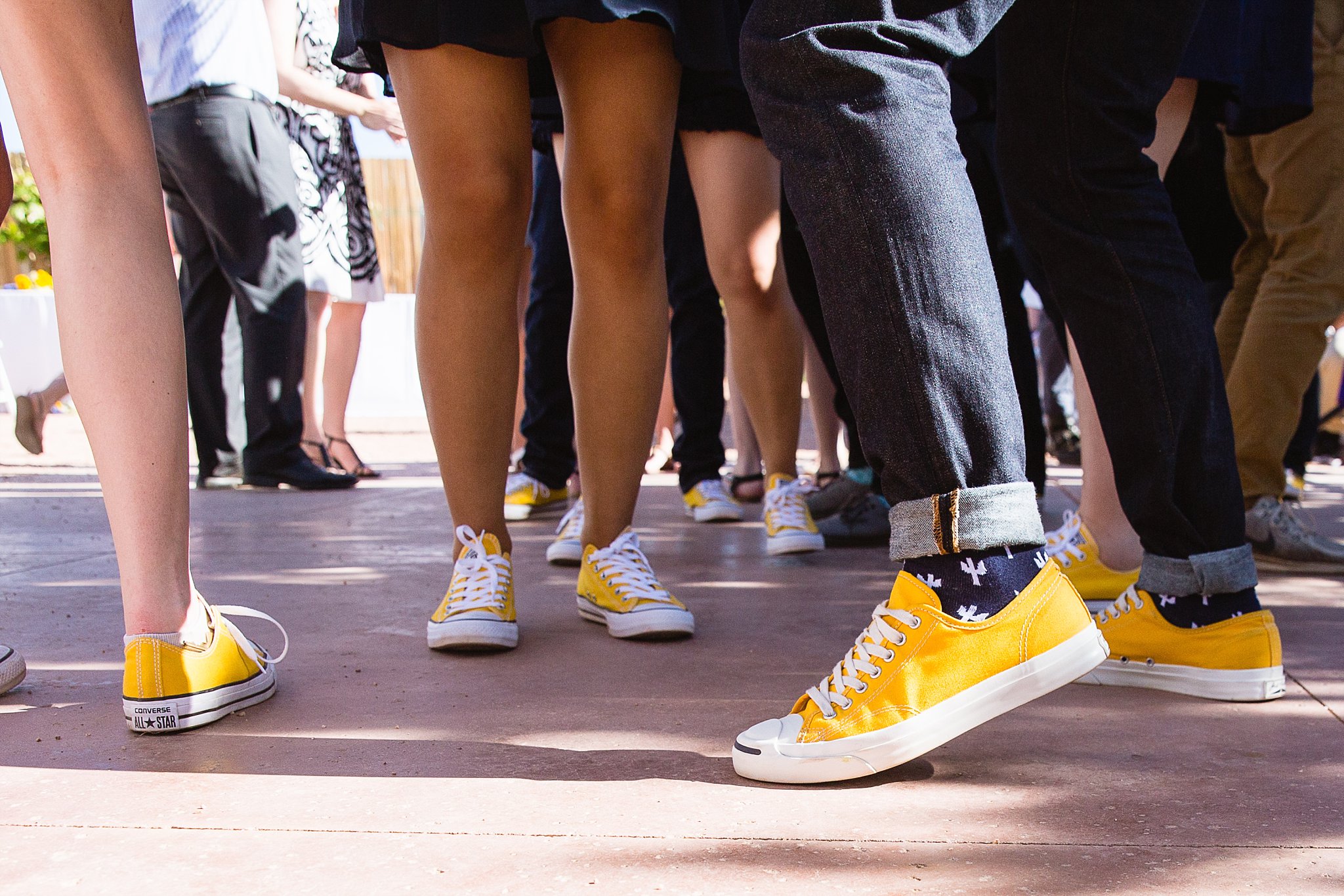 Bridal party's yellow converse while they are dancing at the wedding reception at a Sky Ranch Lodge wedding by PMA Photography.