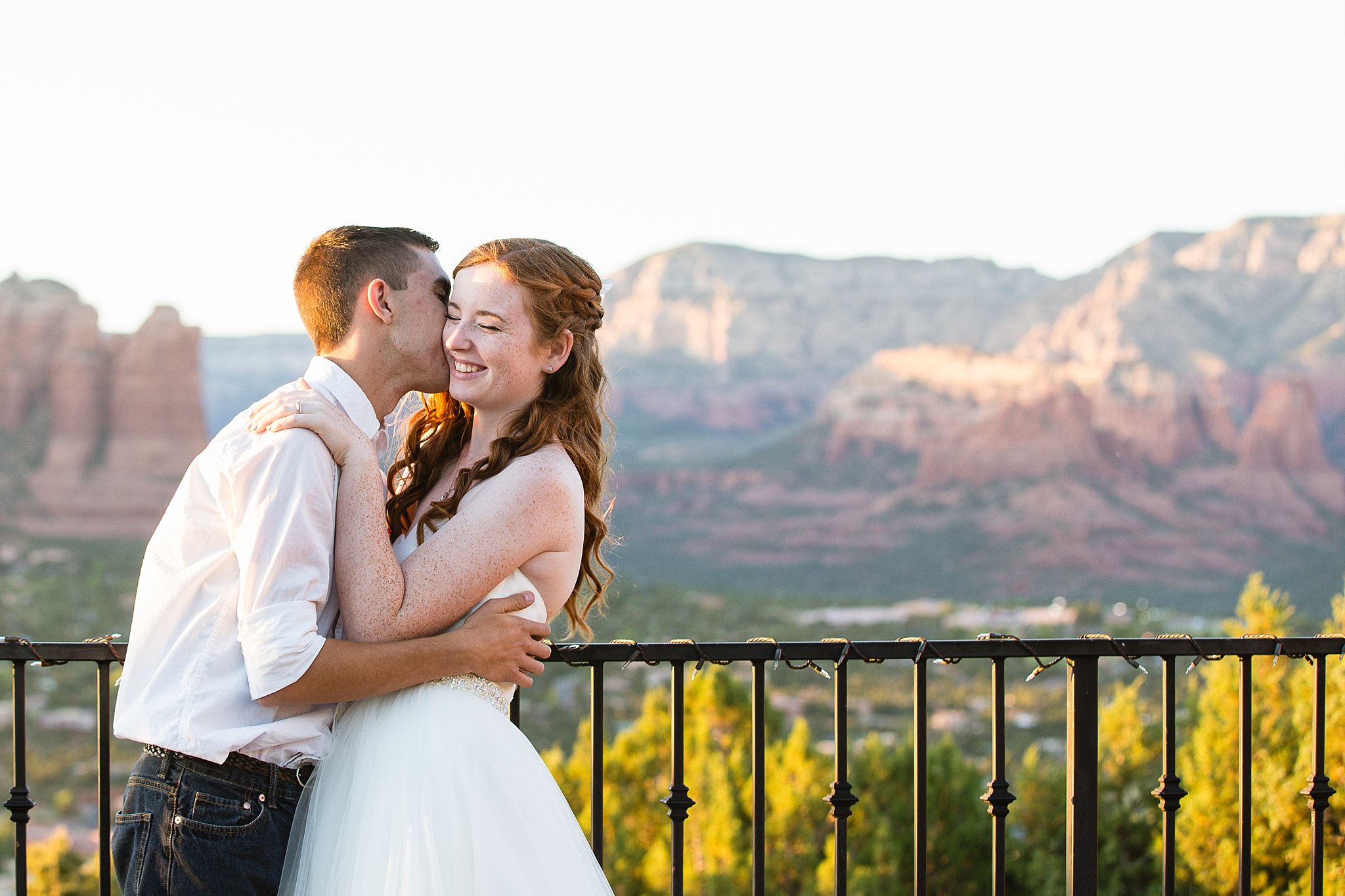 Bride and groom laughing together during their Sky Ranch Lodge wedding by Sedona engagement photographer PMA Photography.