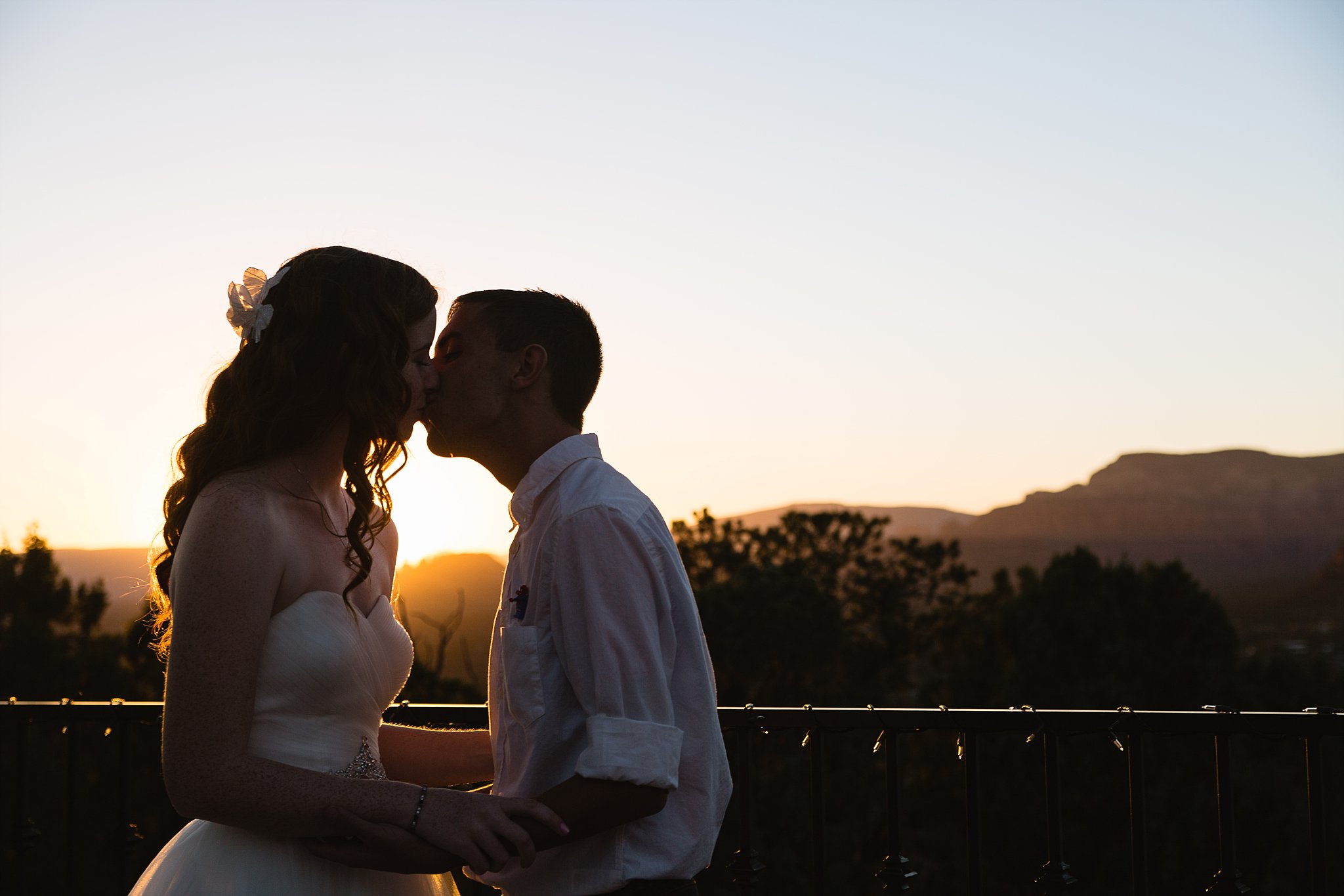 Bride and groom share a kiss during their Sky Ranch Lodge wedding by Sedona wedding photographer PMA Photography.