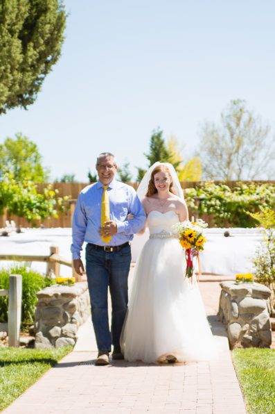 Bride walking down the aisle with her step father by PMA Photography.