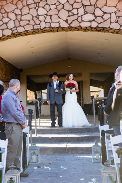 Classic bride walking down the aisle with her father by PMA Photography.