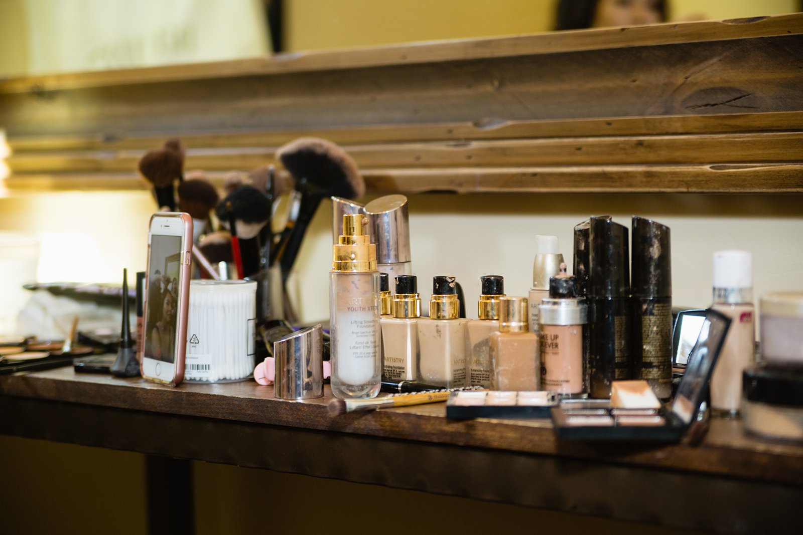 Makeup table as the bride gets ready for her wedding by PMA Photography.