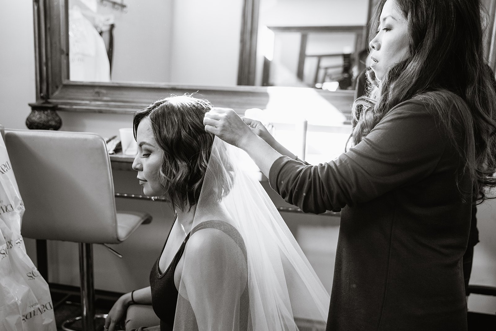 Bride getting her hair done on her wedding day by Arizona wedding photographer PMA Photography.