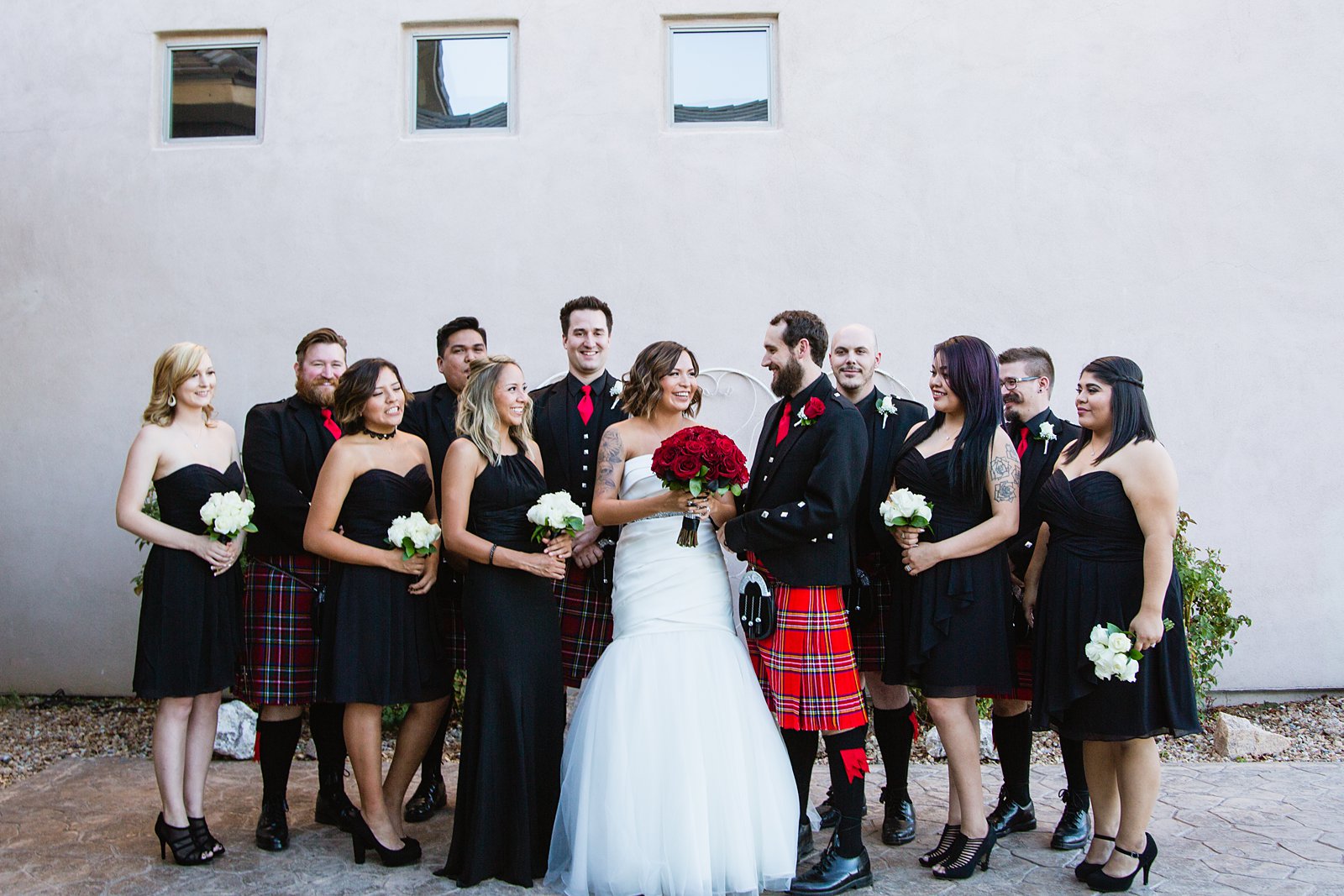 Classic black and red wedding party with the groomsmen in Scottish kilts by Arizona wedding photographer PMA Photography.