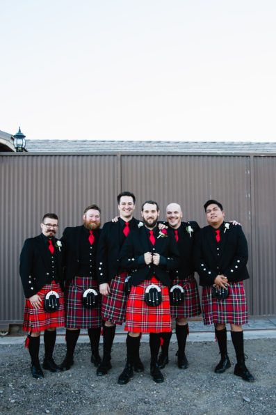 Classic black and red wedding groomsmen in Scottish kilts by Arizona wedding photographer PMA Photography.