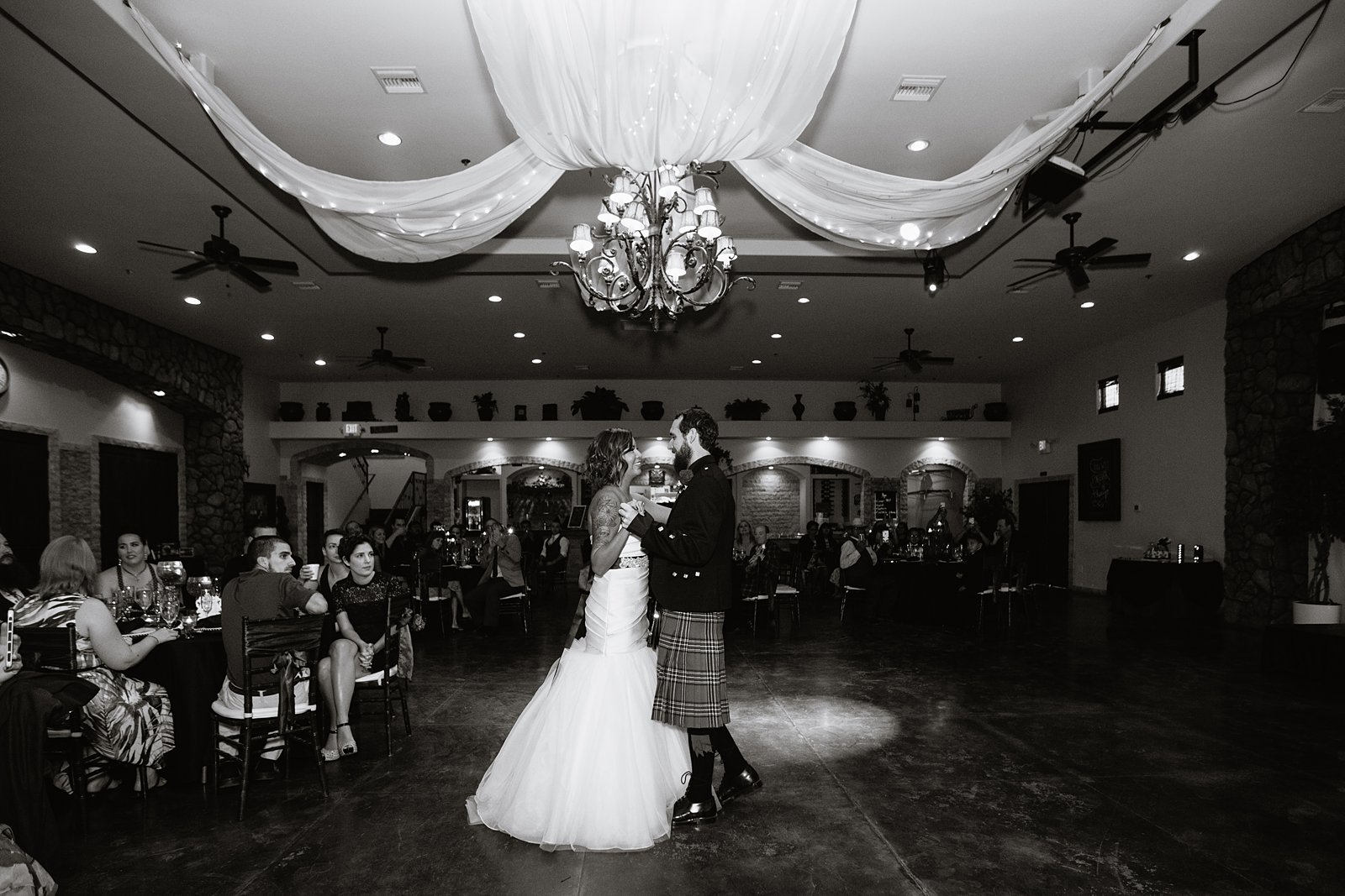Bride and groom share their first dance at the Superstition Manor by Arizona wedding photographers PMA Photography.