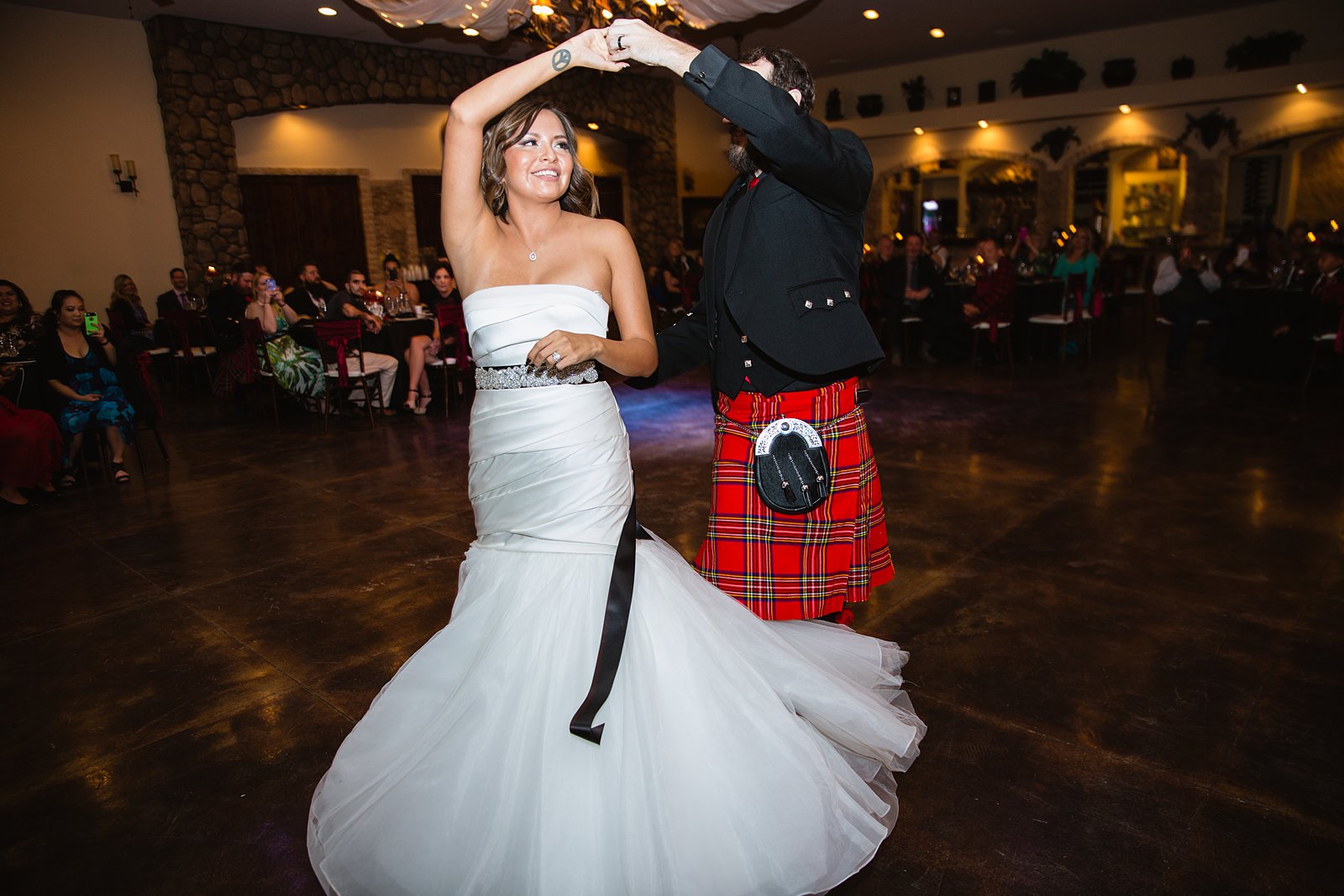 Bride and groom share their first dance at the Superstition Manor by Arizona wedding photographers PMA Photography.