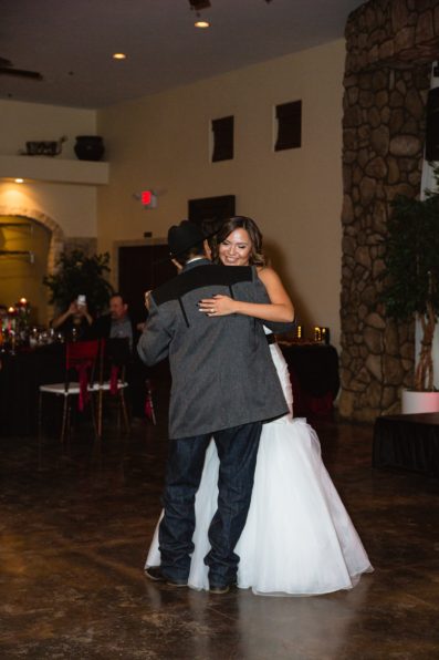 Bride dances with her father at the Superstition Manor by Arizona wedding photographers PMA Photography.