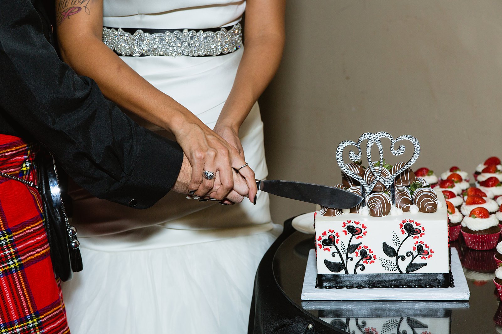 Bride and groom cutting the cake during their wedding reception at the Superstition Manor by PMA Photography.