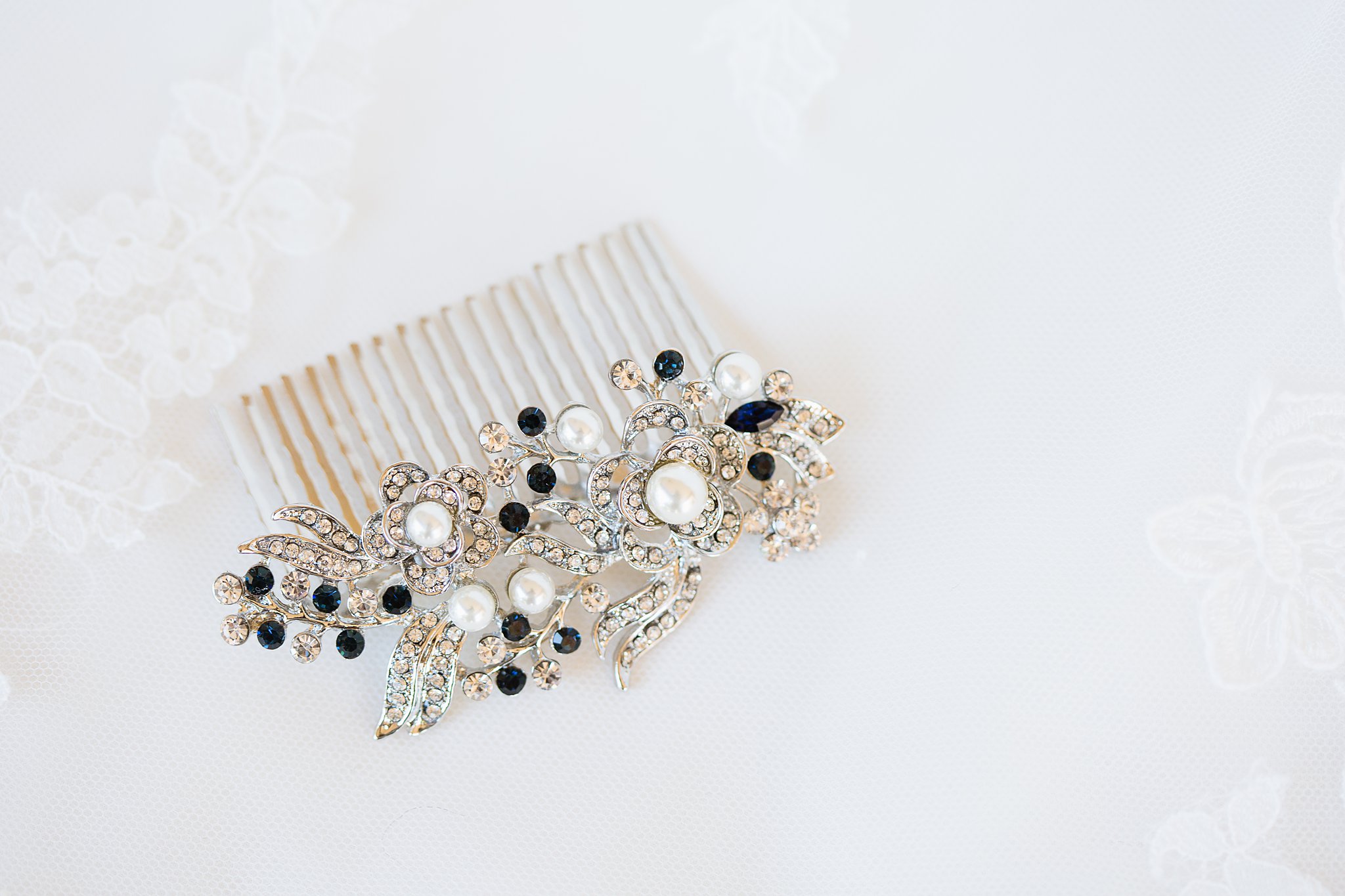 Brides's wedding day details of a something blue hairpiece by PMA Photography.