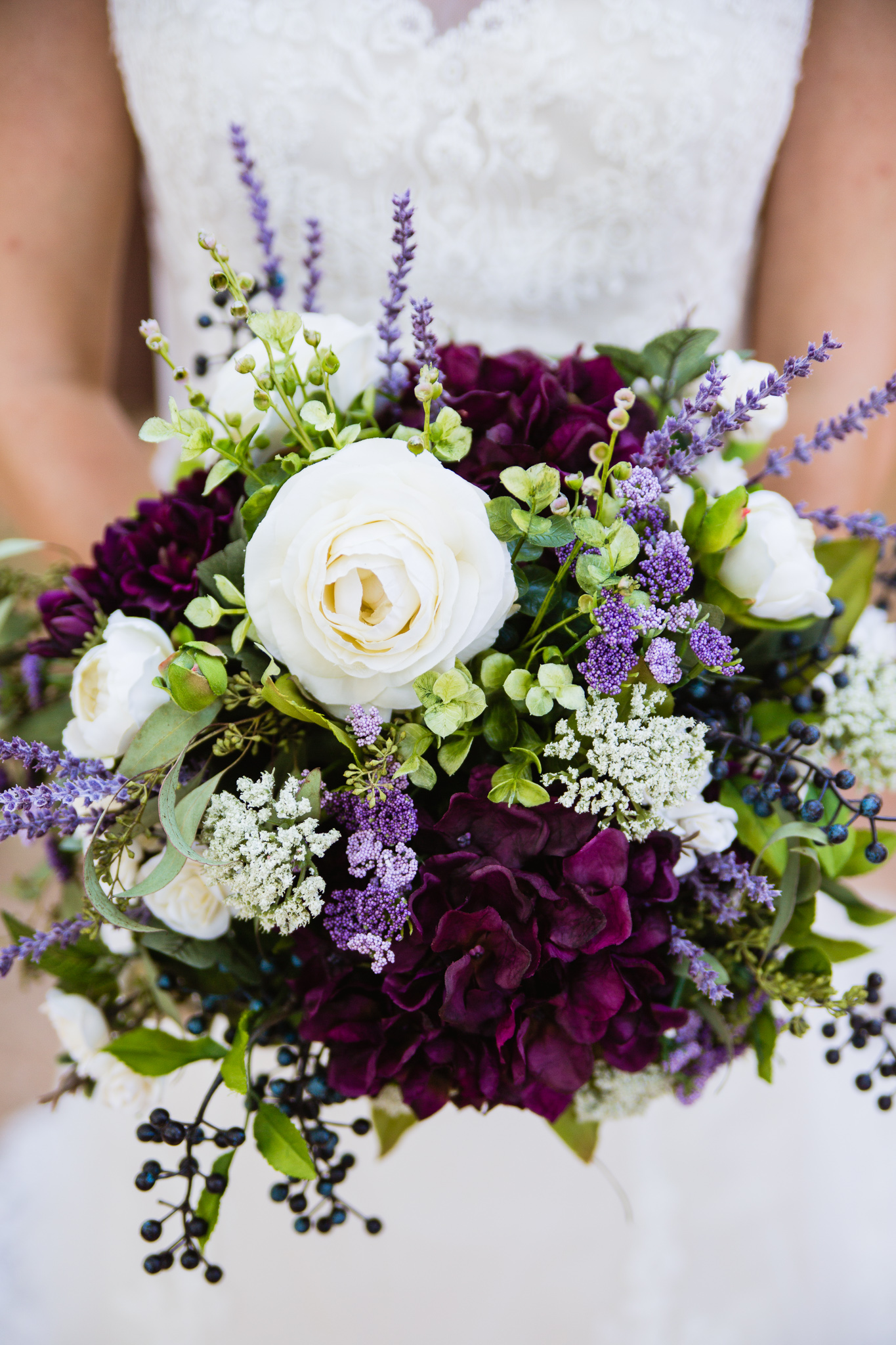 Purple, white, and green silk bridal bouquet by wedding photographer PMA Photography.