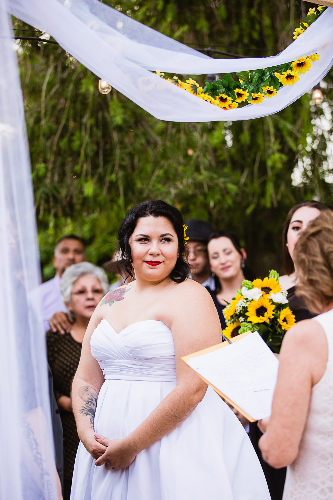 Bride during LGBT backyard garden ceremony by Phoenix wedding photographer PMA Photography.