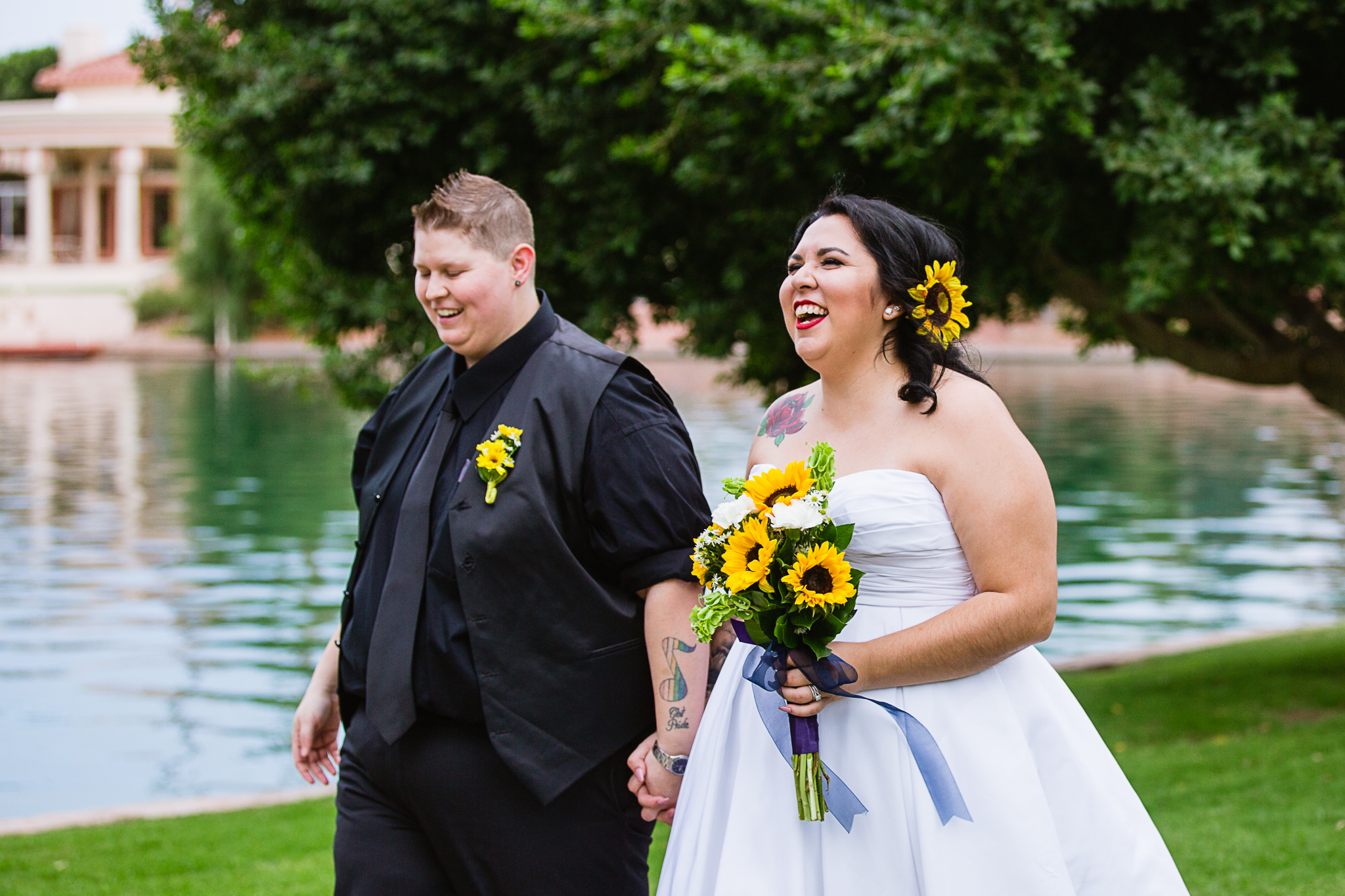 LGBT couple walking by a lake on their wedding day by Phoenix wedding photographers PMA Photography.