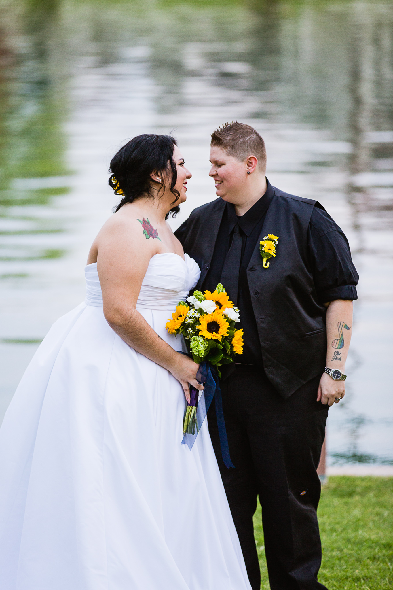 LGBT couple in front of a small lake on their wedding day by Phoenix wedding photographers PMA Photography.