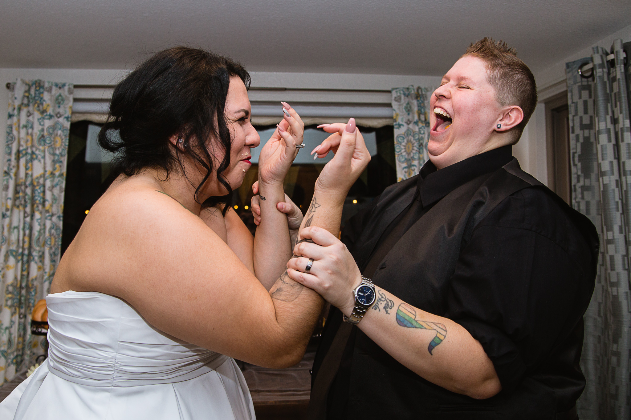 Same sex couple share a long john donut instead of cake on their wedding night.