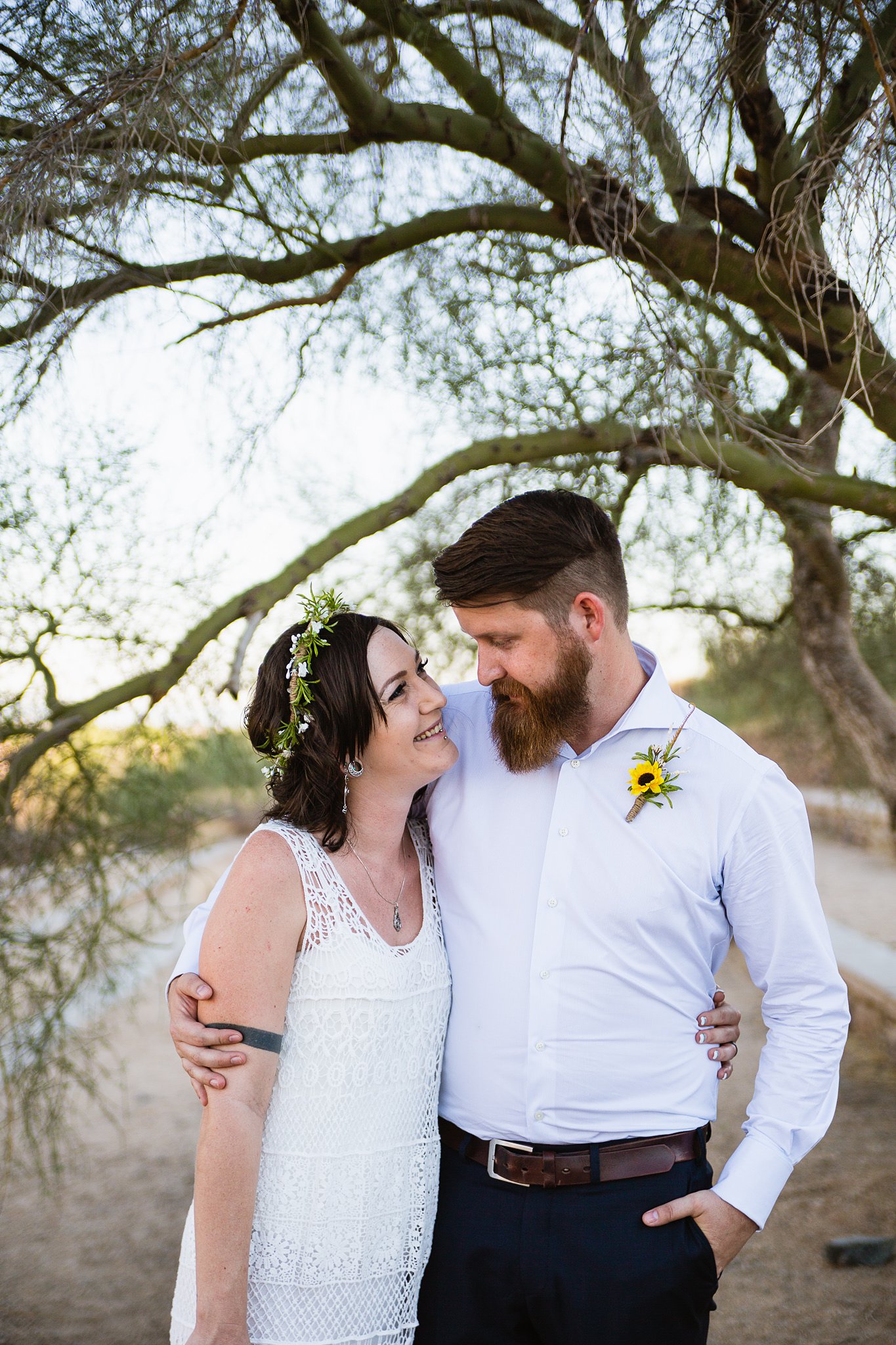 Simple boho inspired bride and groom share a laugh by Phoenix wedding photographer PMA Photography.