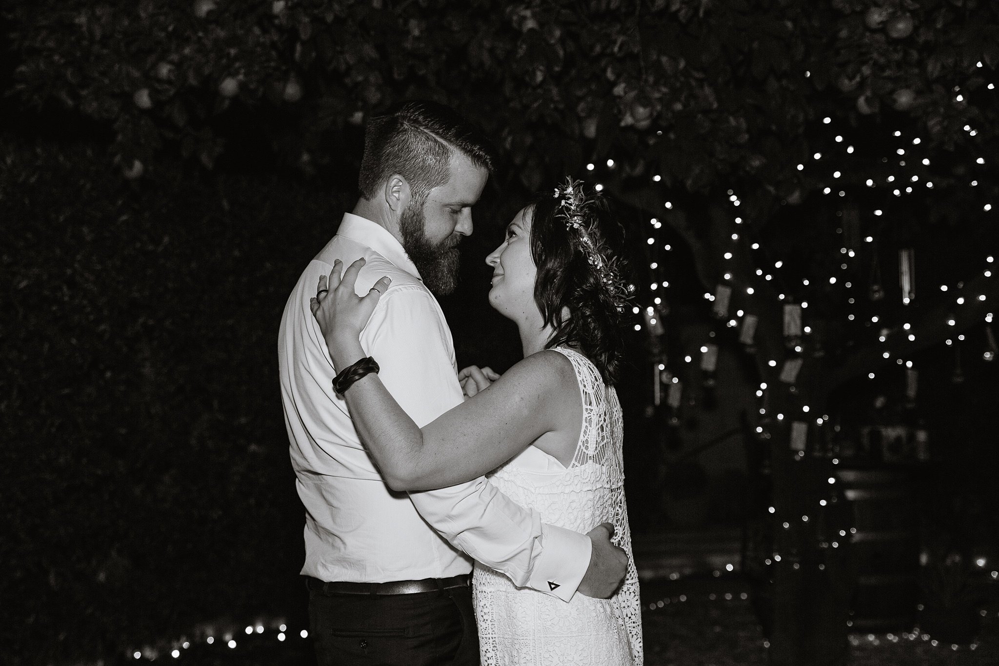 Black and white image of the bride and groom dancing at their backyard garden wedding by PMA Photography.