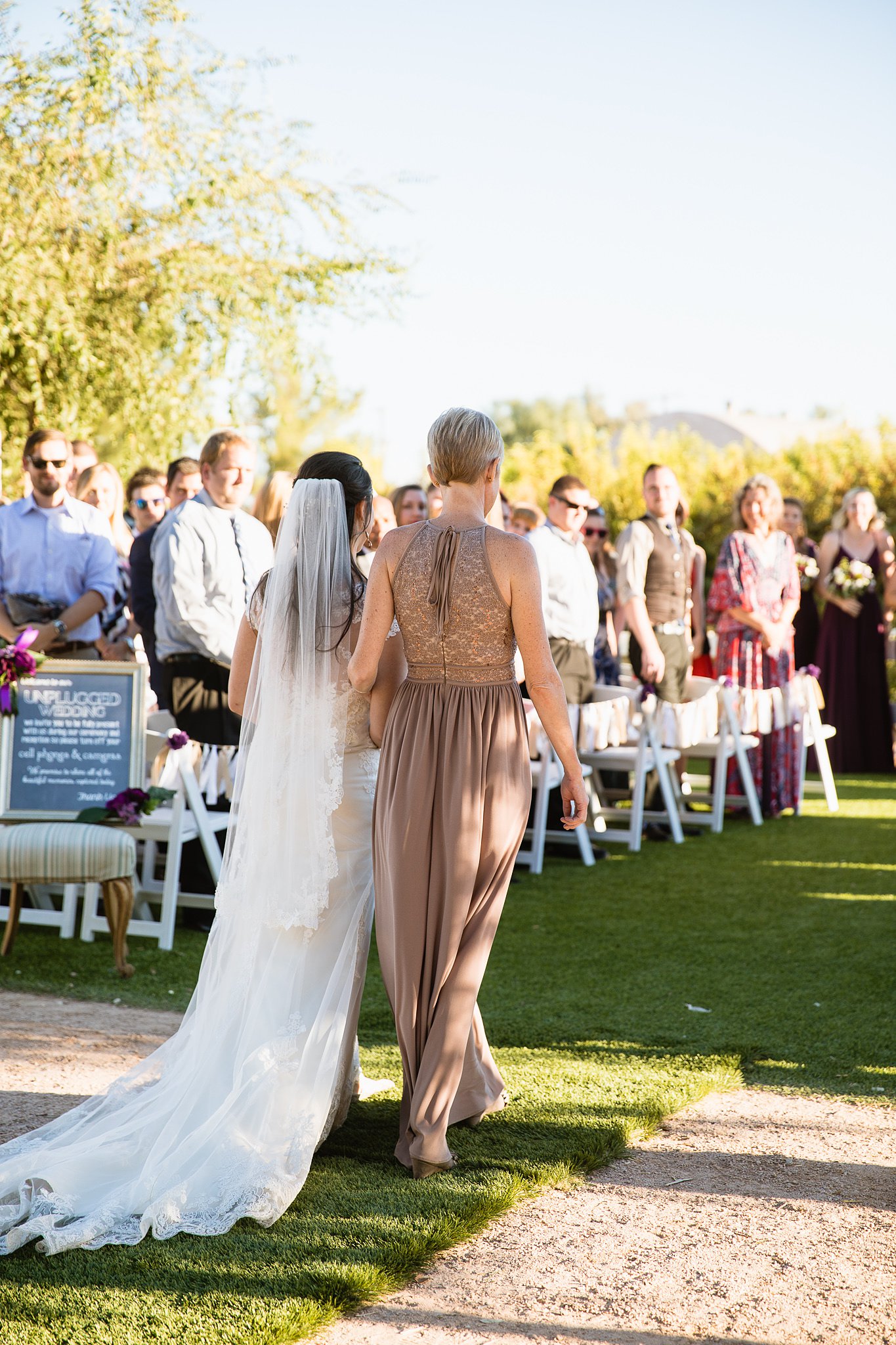 Bride and mother walking down the aisle at the Farmhouse at Schenpf Farms by Phoenix wedding photographer PMA Photography.