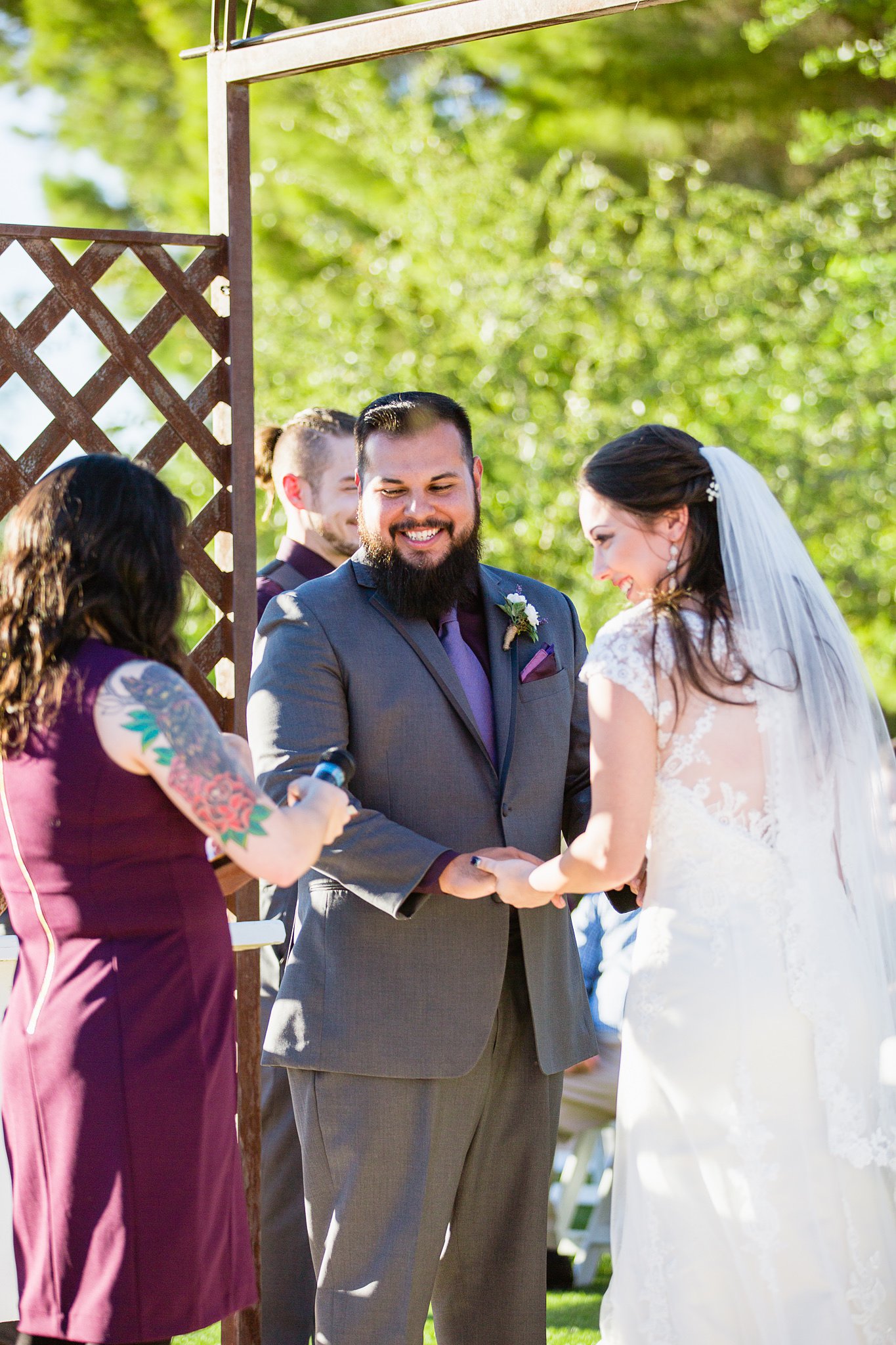 Bride and groom sharing a laugh during their wedding ceremony at the Schnepf Farm's Farmhouse by Arizona wedding photographer PMA Photography.