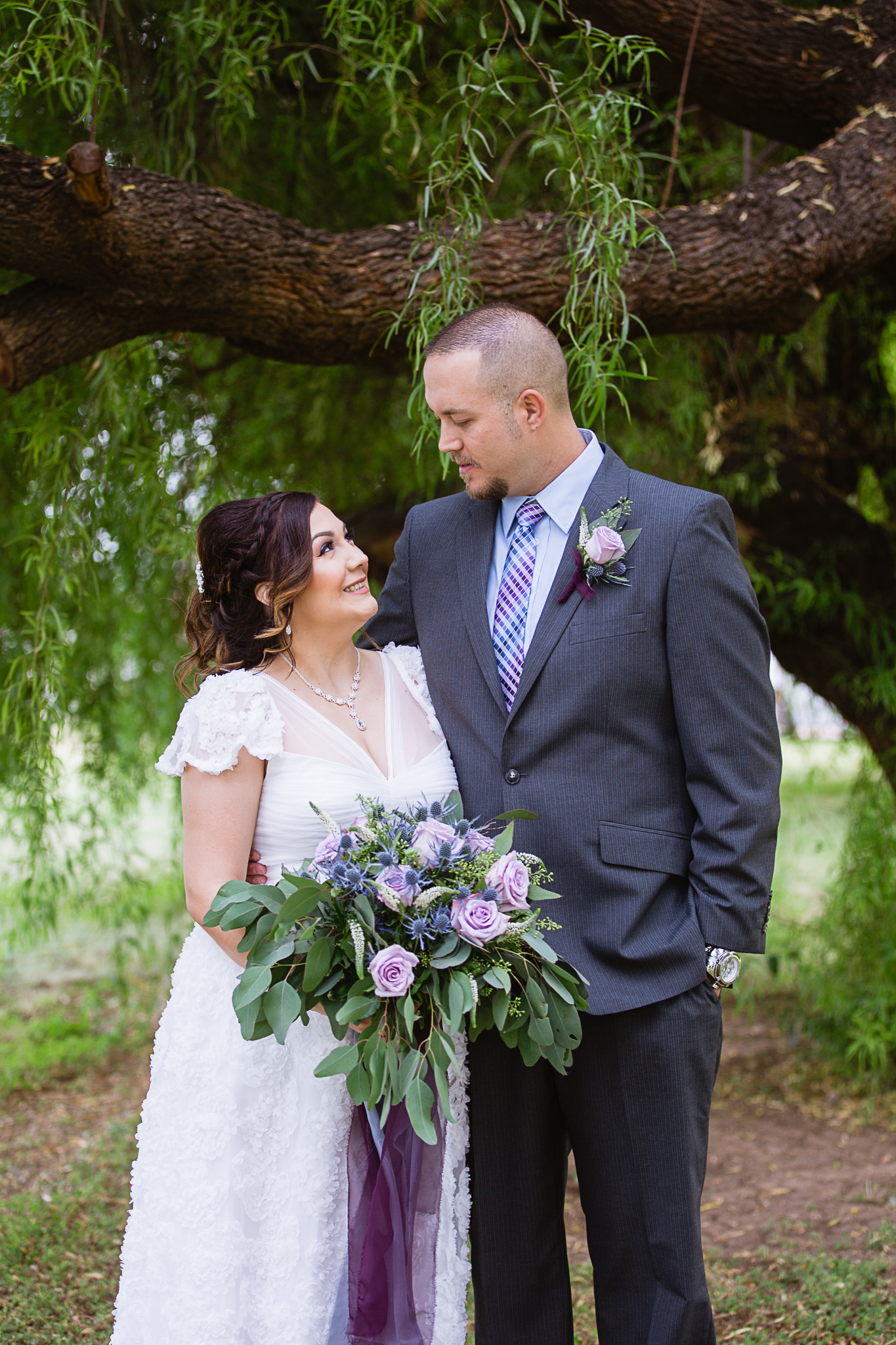 Bride and groom at their lavender and dusty blue backyard wedding in Arizona by wedding photographer PMA Photography.