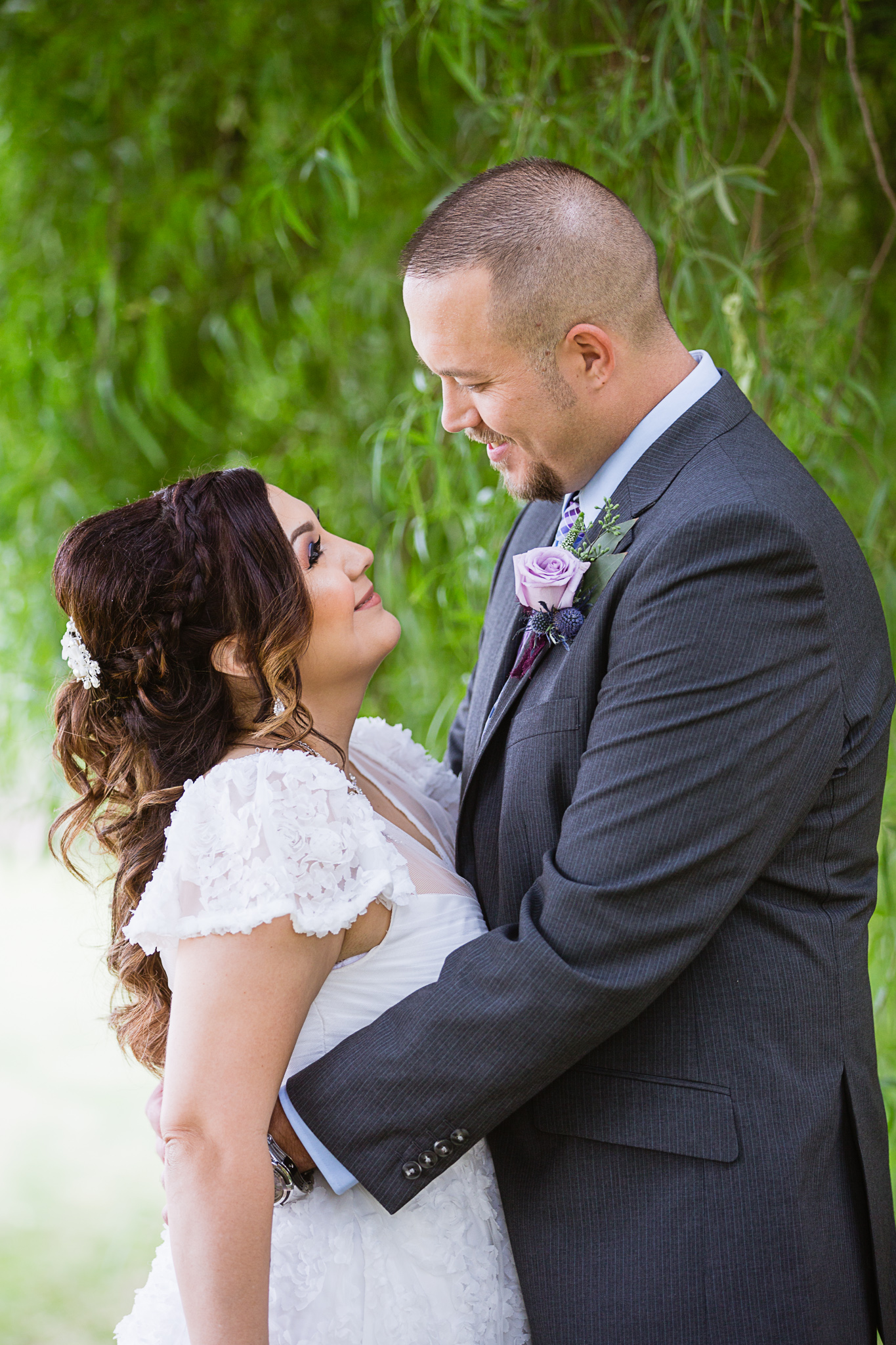 Bride and groom look lovingly at each other on their wedding day by Arizona wedding photographer PMA Photography.