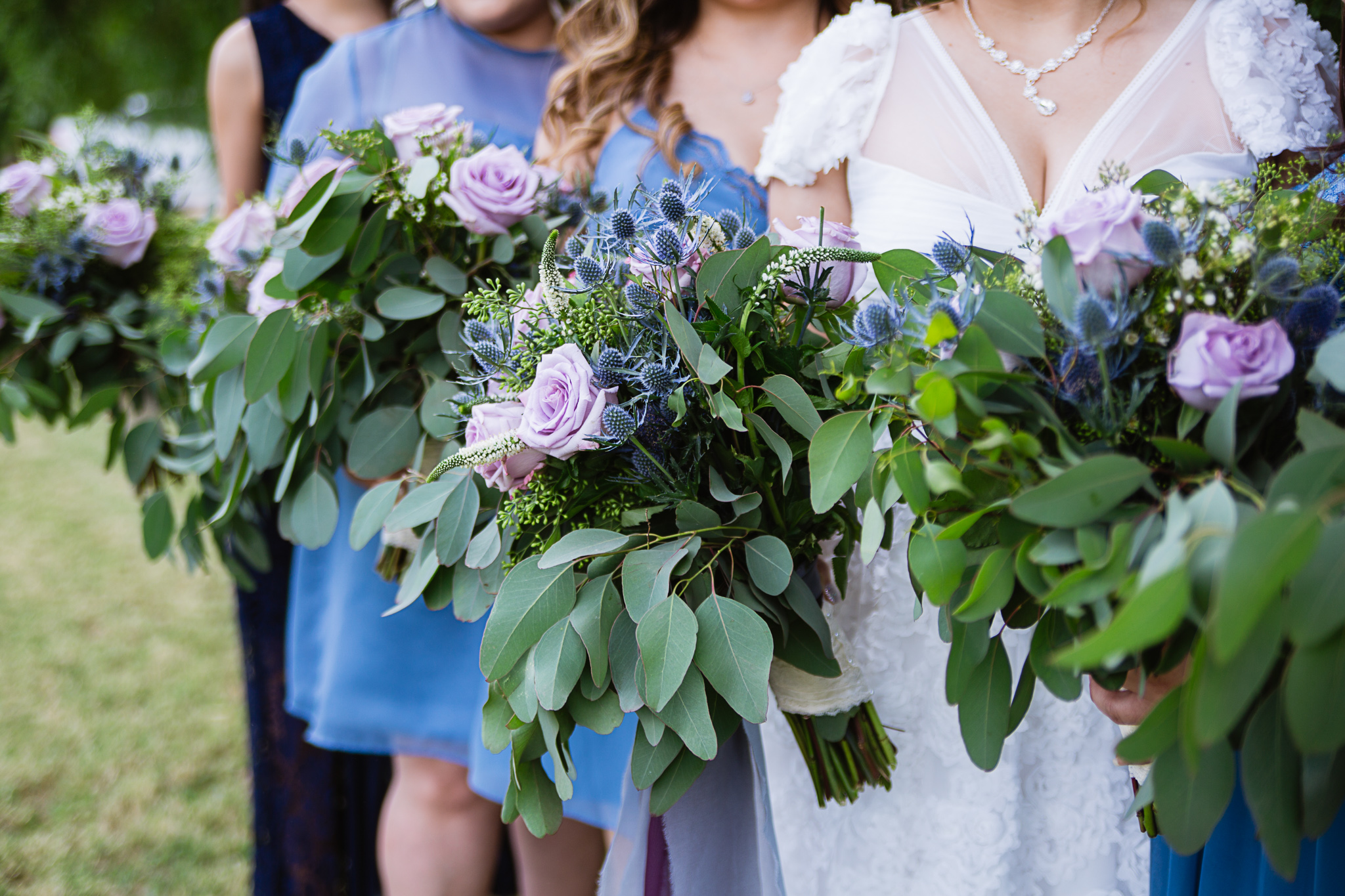 Lavender rose, blue thistle, and eucalyptus bouquets by Arizona wedding photographer PMA Photography.