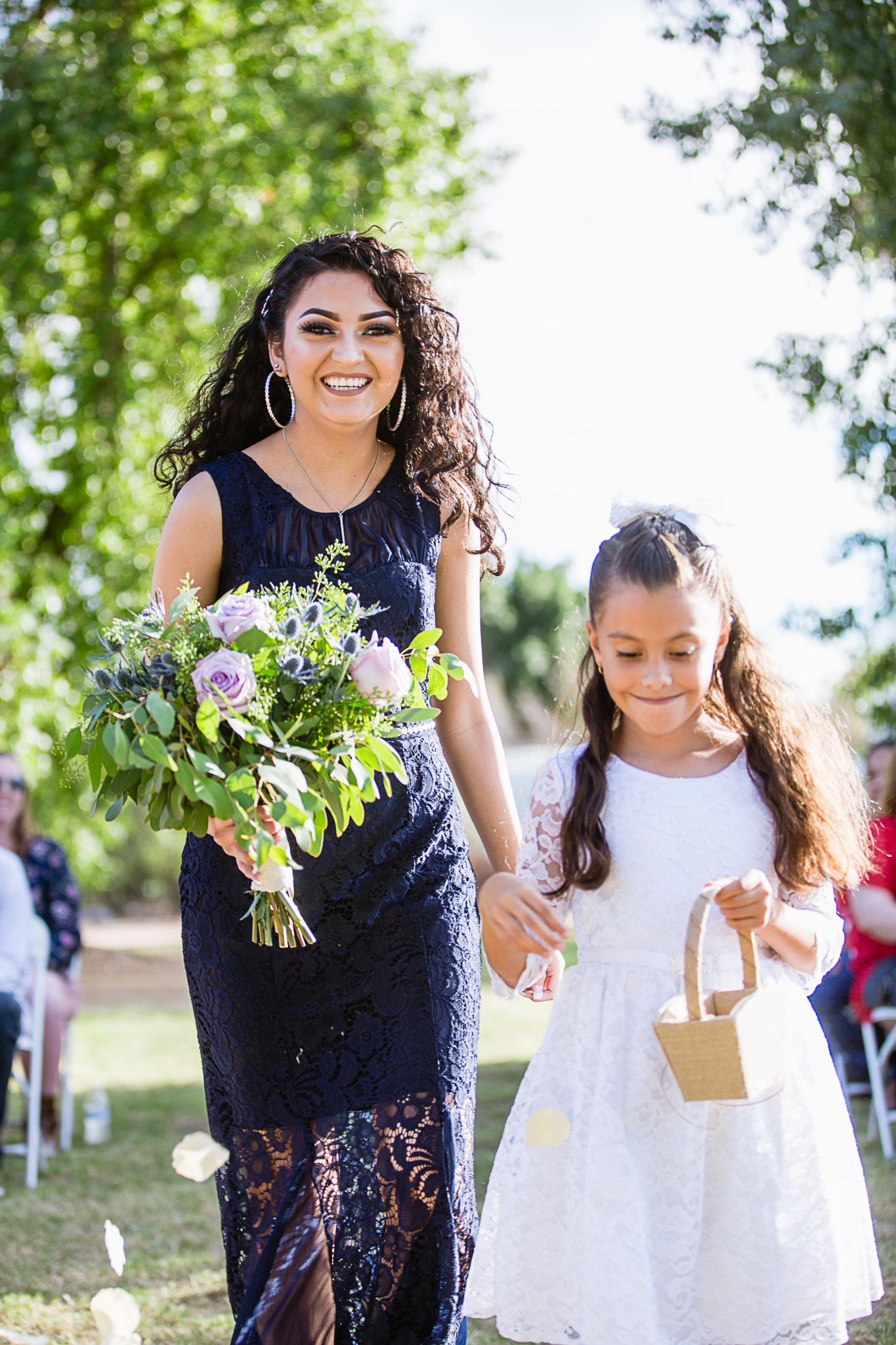 Flower girls walking down the aisle by PMA Photography.