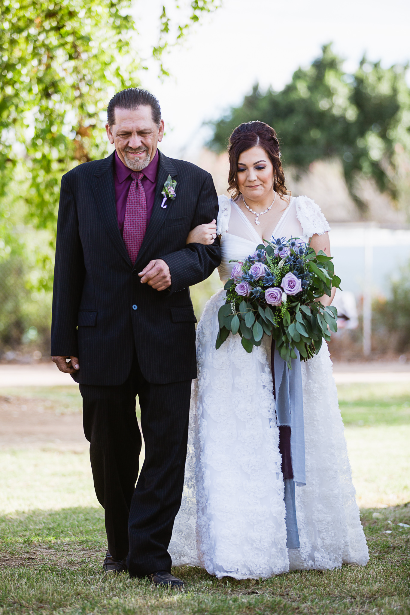 Bride walking down the aisle with her father by PMA Photography.