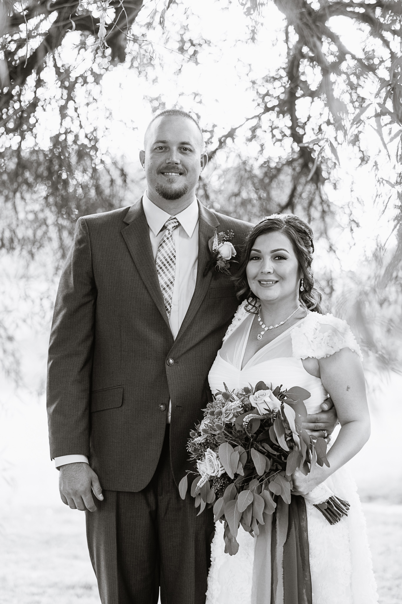 Black and white image of bride and groom on their wedding day by PMA Photography.