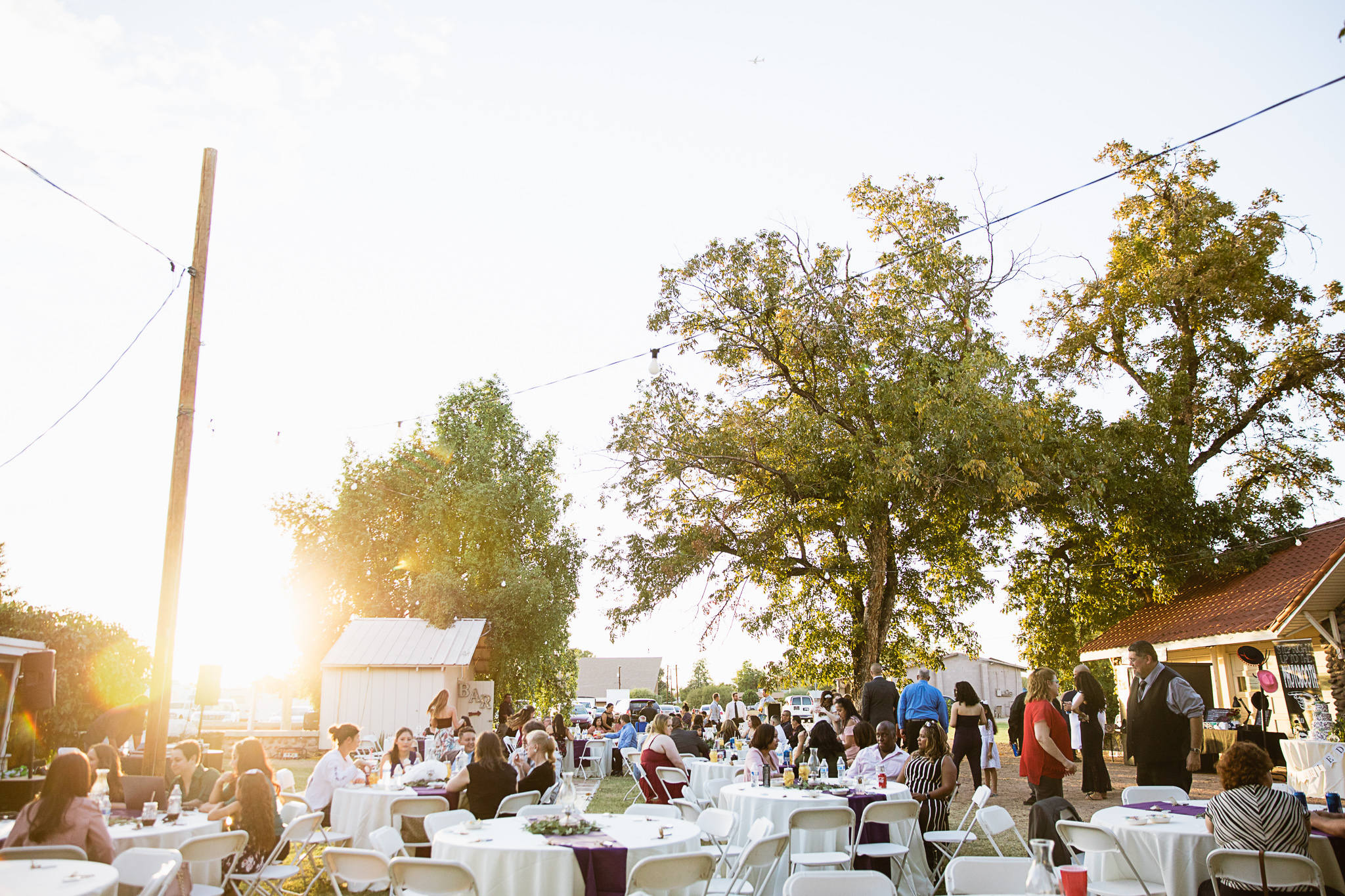 Backyard wedding reception as the sun is setting by PMA Photography.