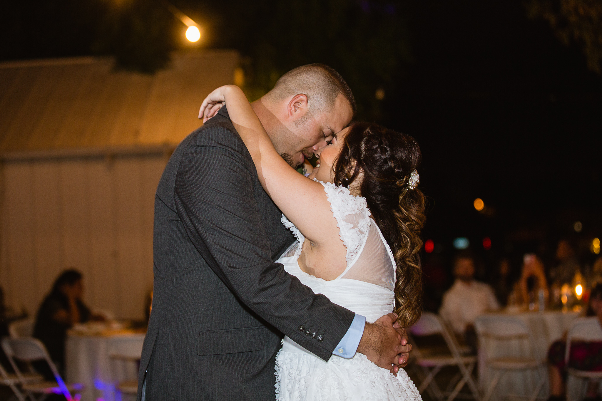 Bride and groom share a sweet moment during their first dance by PMA Photography.