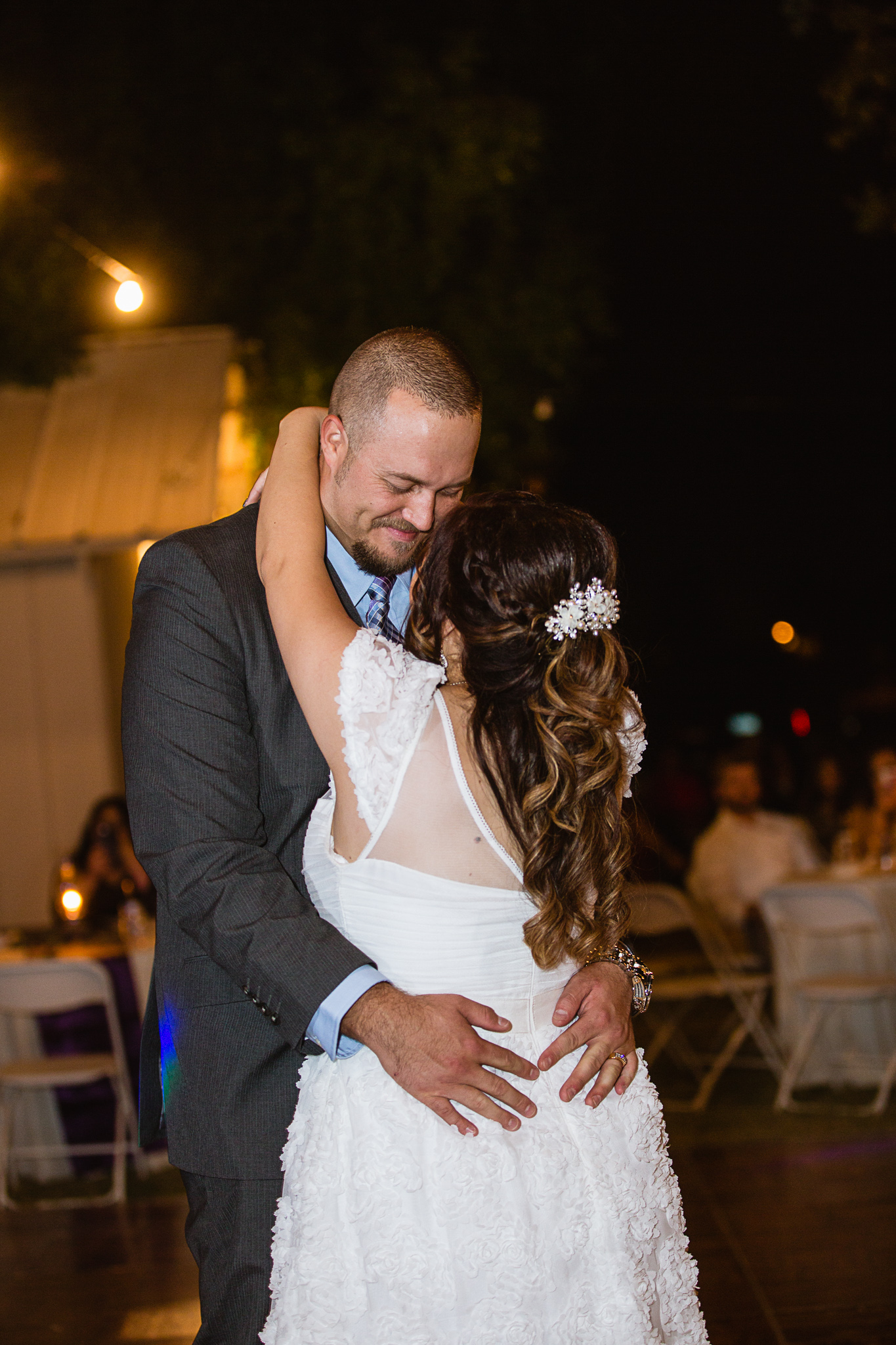 Bride and groom share their first dance during their wedding reception by PMA Photography.