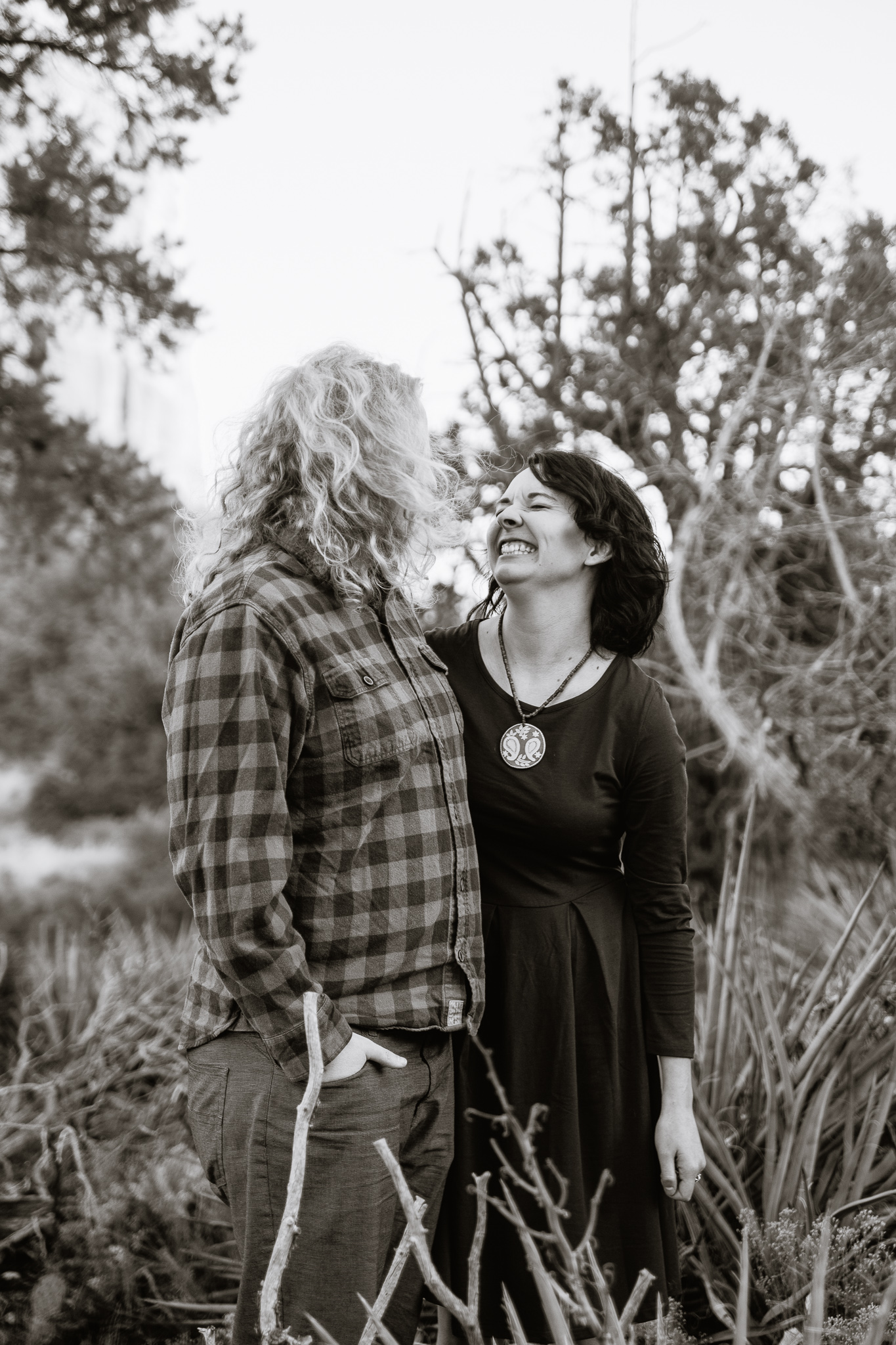 Black and white image of couple laughing together during engagement session by PMA Photography.